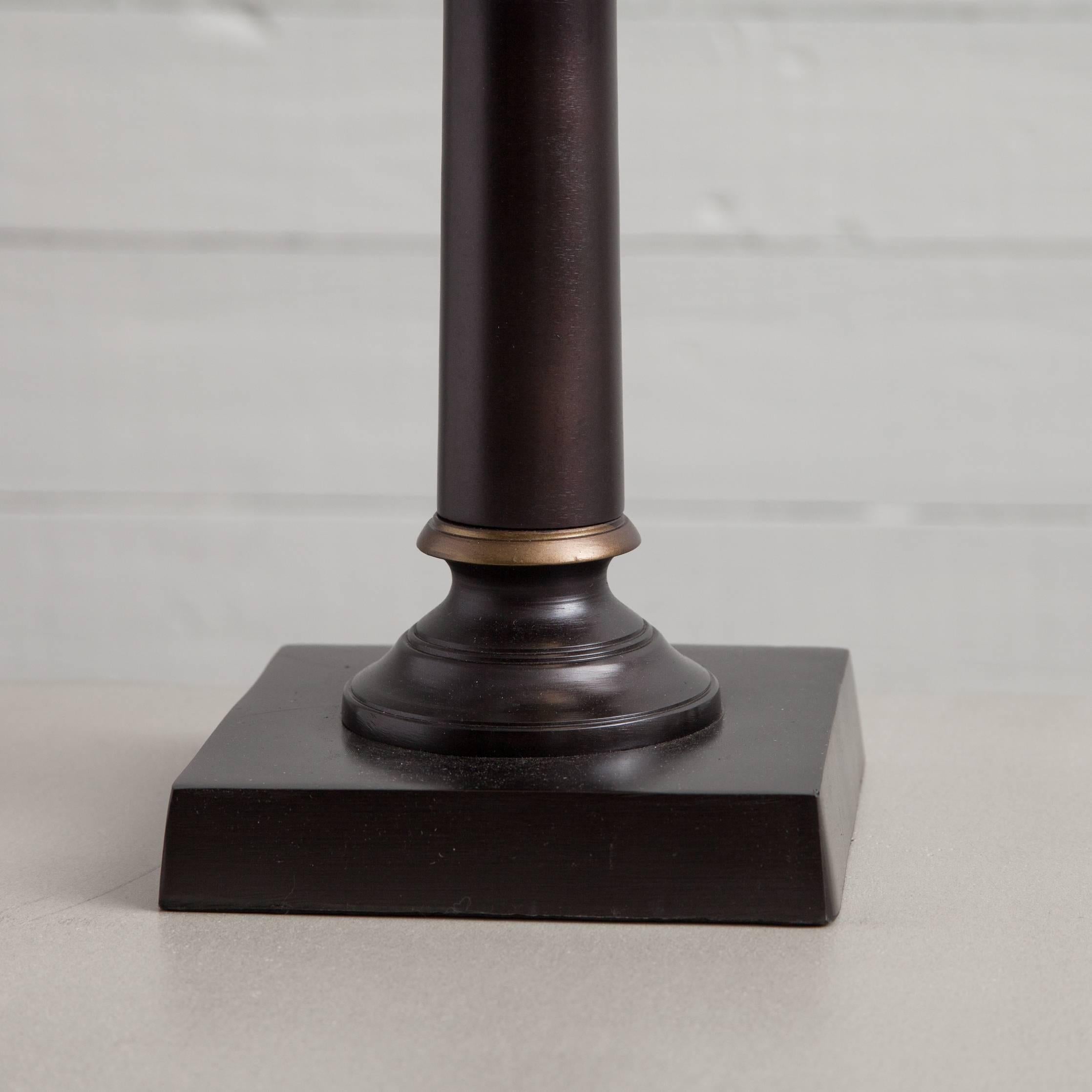 Dramatic black table lamp in oil rubbed bronze with black card shade and golden details.

Dimensions: W 14