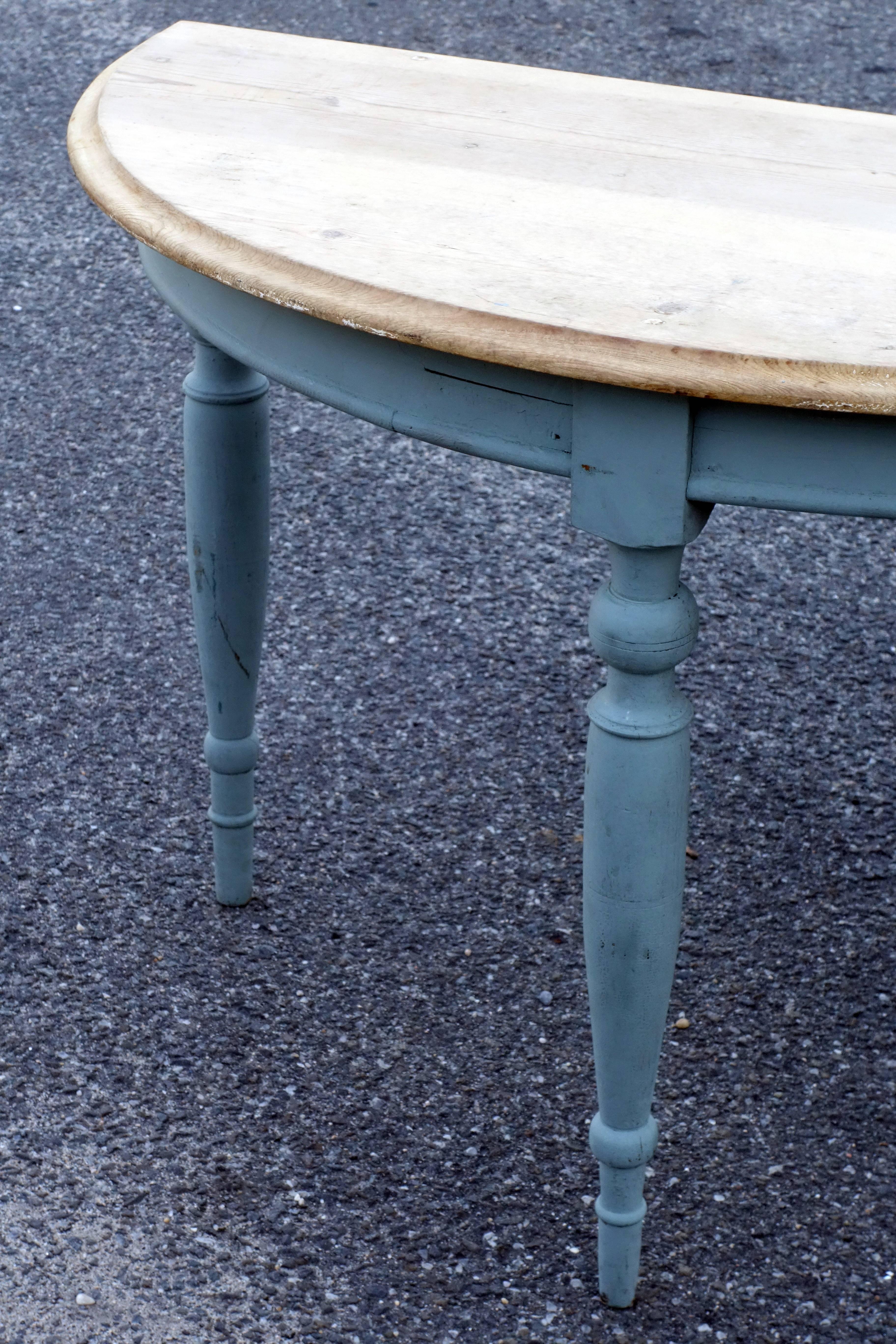 A pair of English pine demilune tables with recently painted bases. Natural pine tops