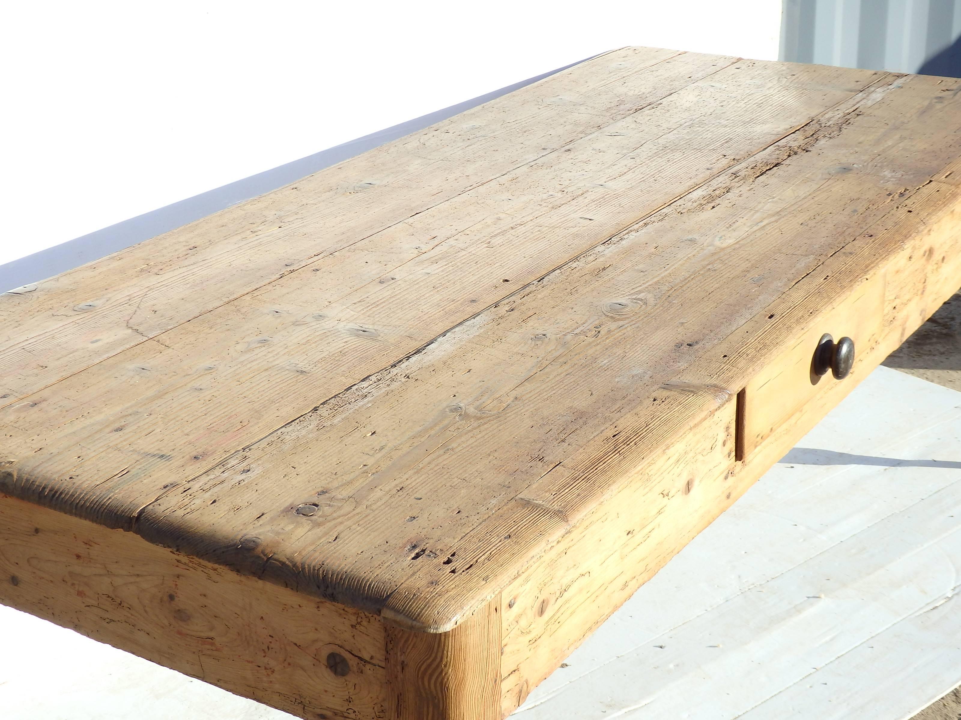 Large pine farmhouse table with turned legs and single drawer. Natural French polish finish, lovely color and patina