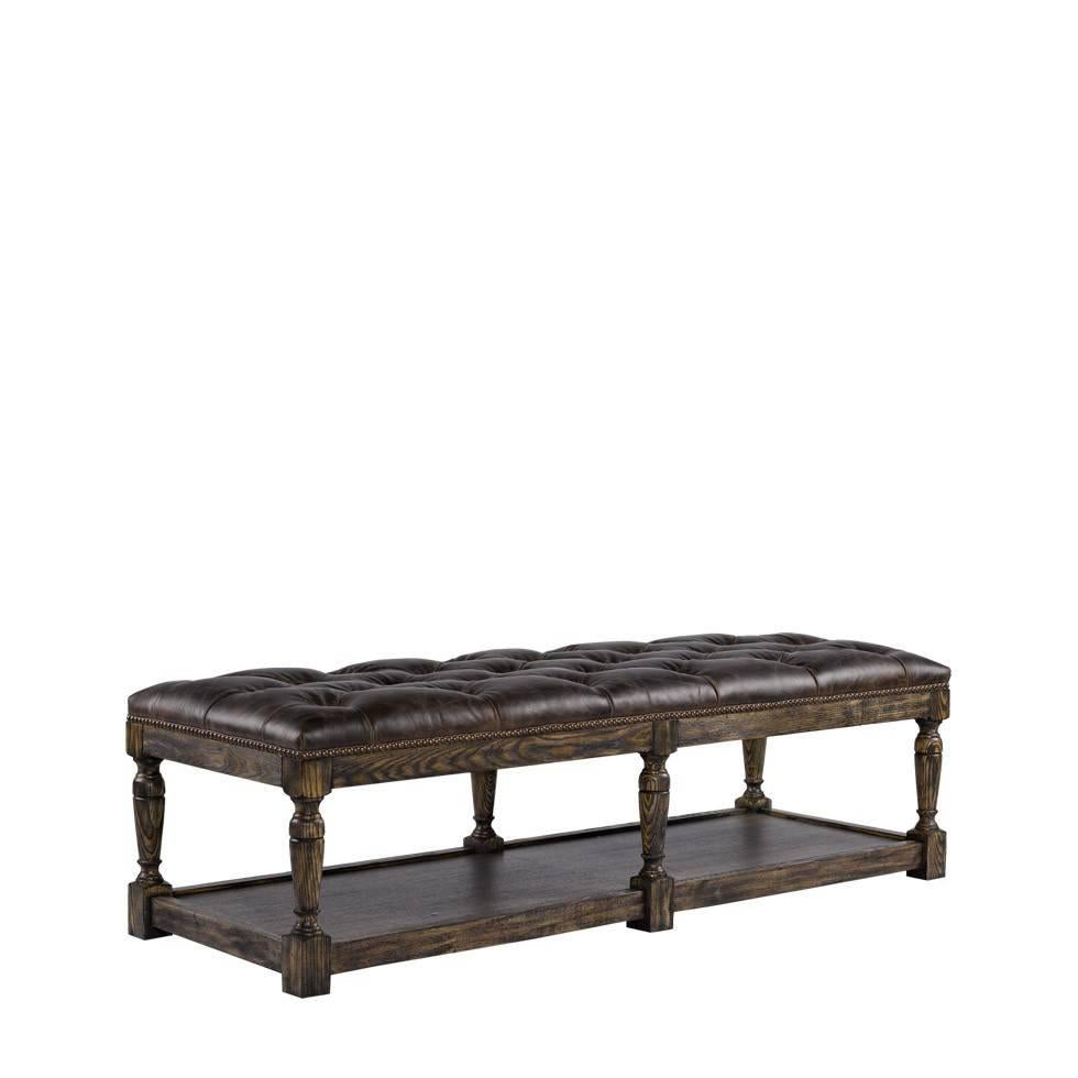 This bench or ottoman features a supple leather tufted cushion with hand-hammered brass nails. The solid wood base is a hand-carved weathered ash frame.