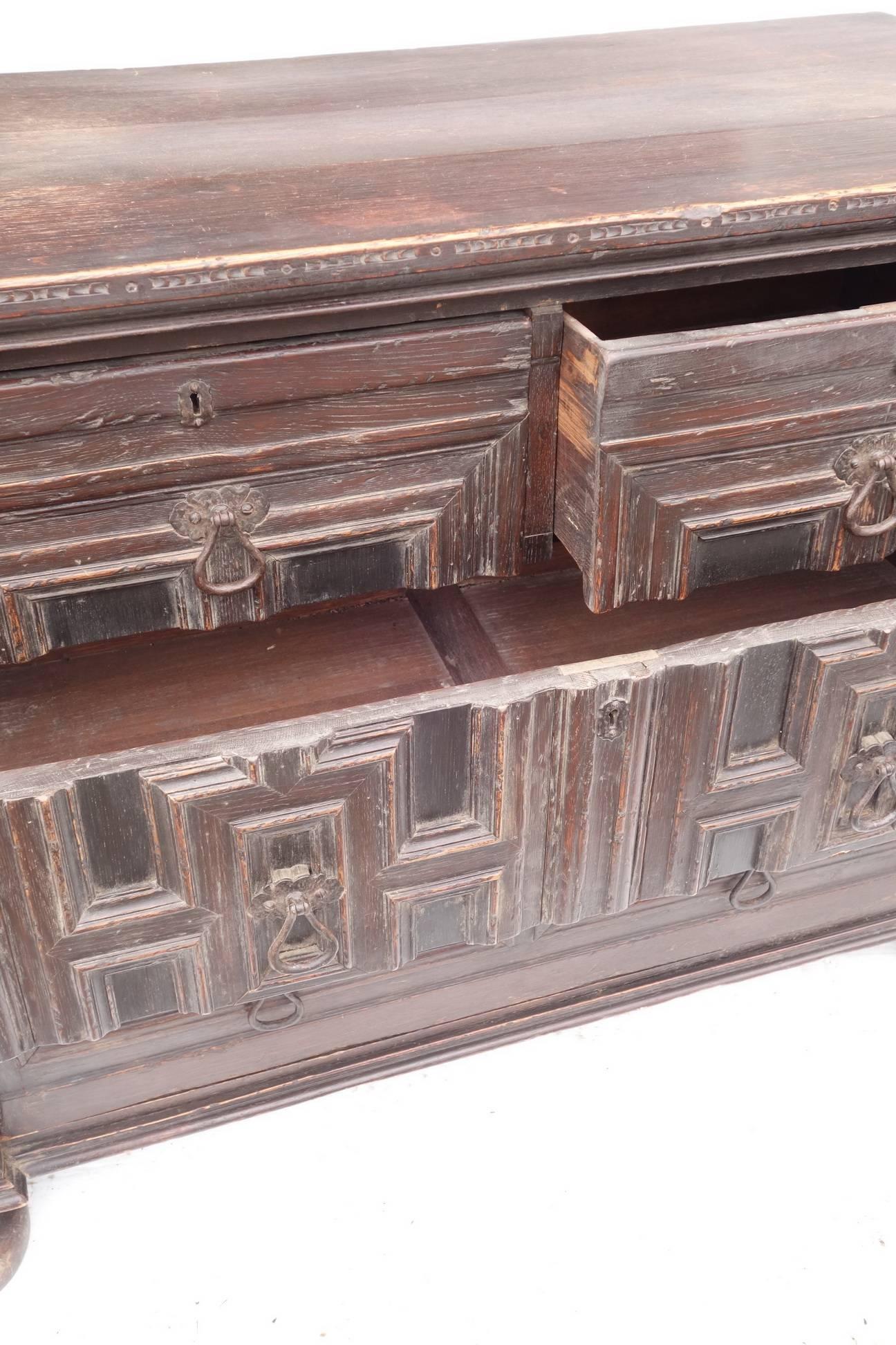 Mahogany dresser with four drawers that look like door when closed. Hand-carved, early 19th century piece on original large bun feet. Original hardware.