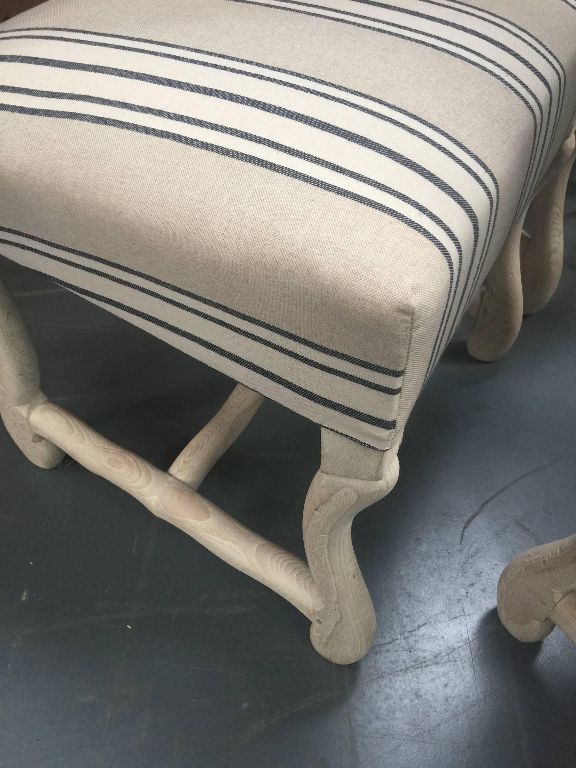 Set of eight French dining chairs including two armchairs and six side chairs, newly upholstered in French stripe linen.