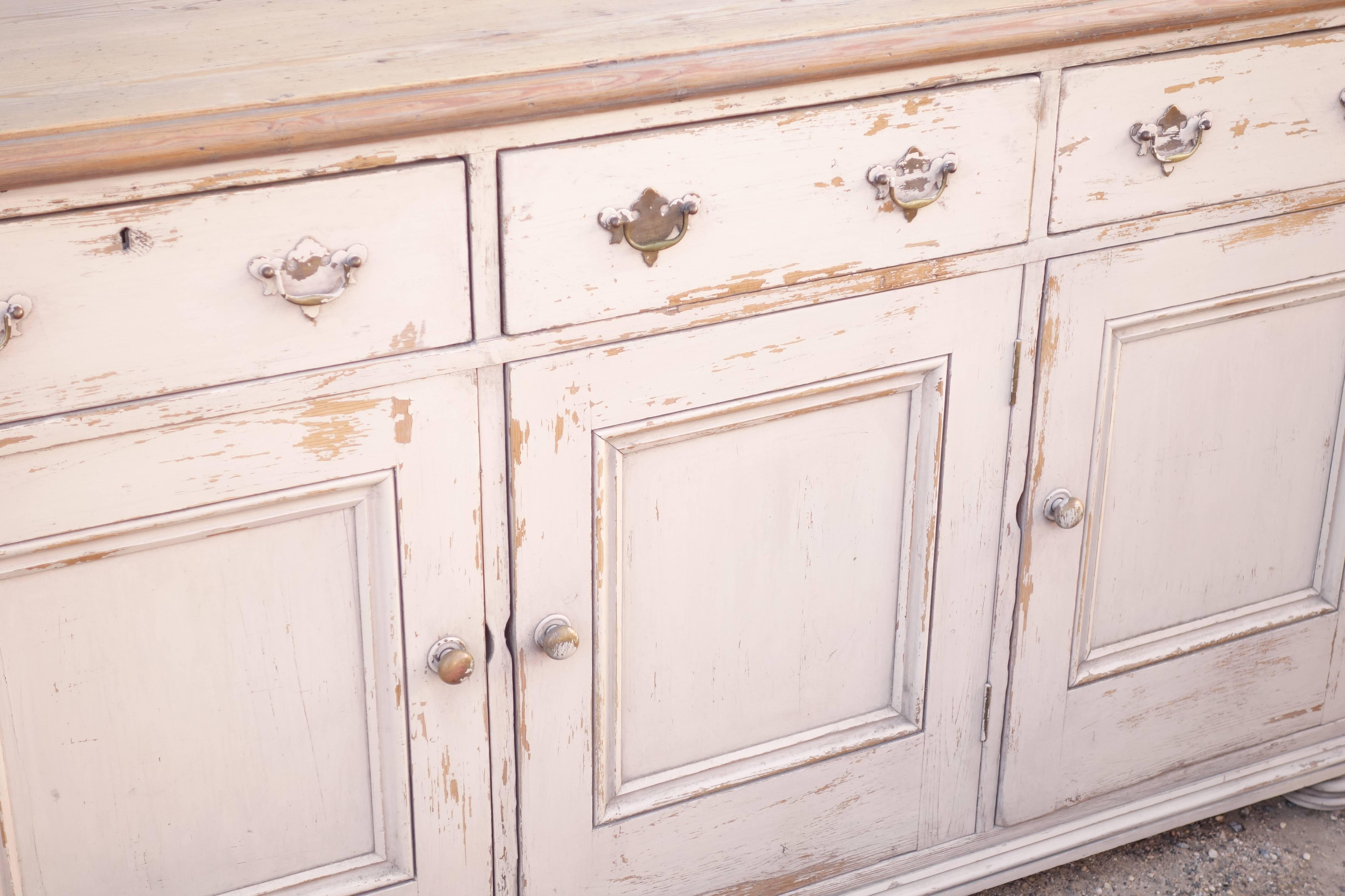 English pine sideboard or dresser base, old ivory paint, brass hardware, natural pine top, great storage.