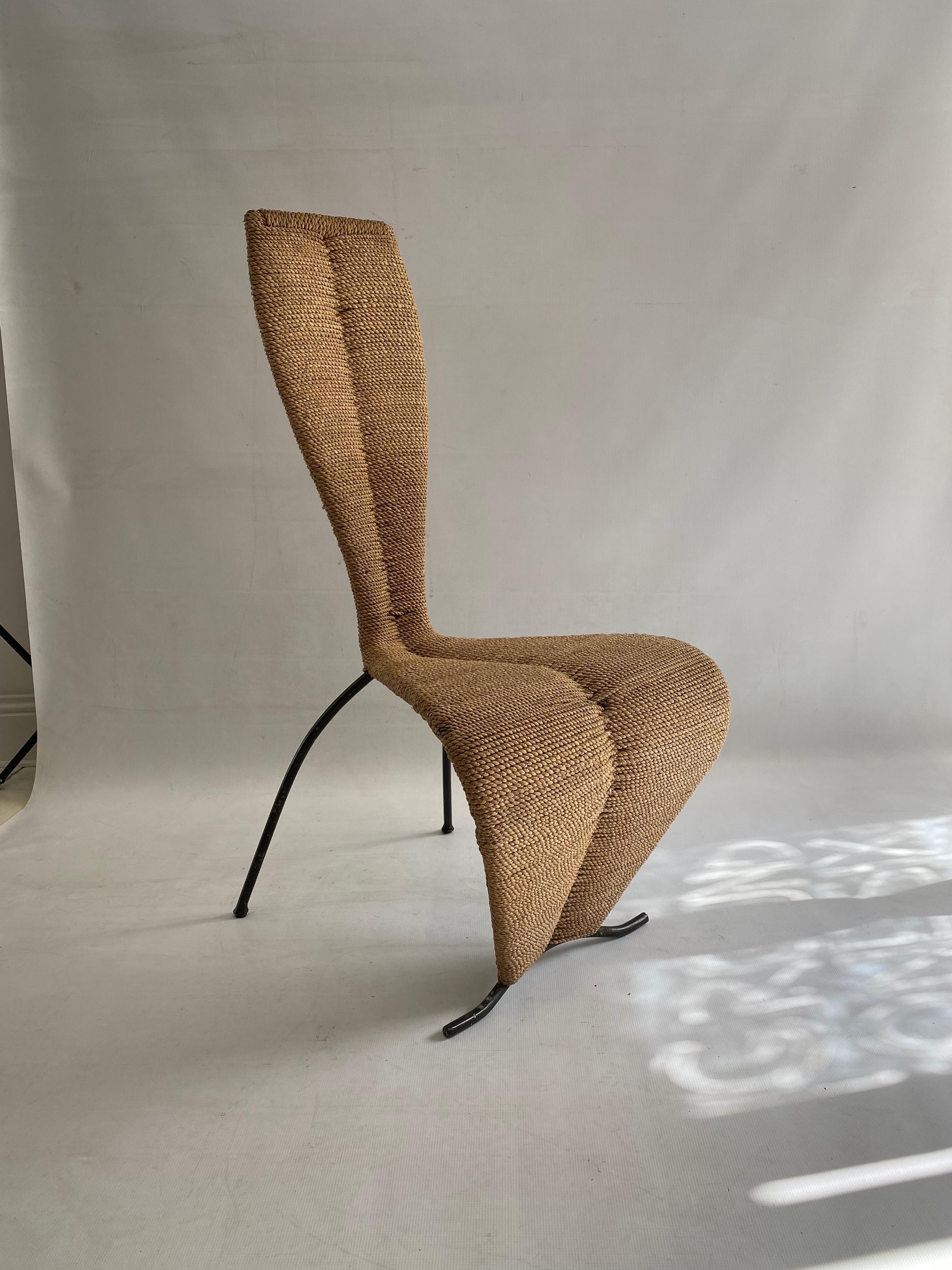 An amazing and rare chair designed after the famous 'S' chair of Tom Dixon. The chair is weaved with rope or rushed around a metal frame. It holds a beautiful hourglass shape that's playful and resembles a seating feminine body making it highly