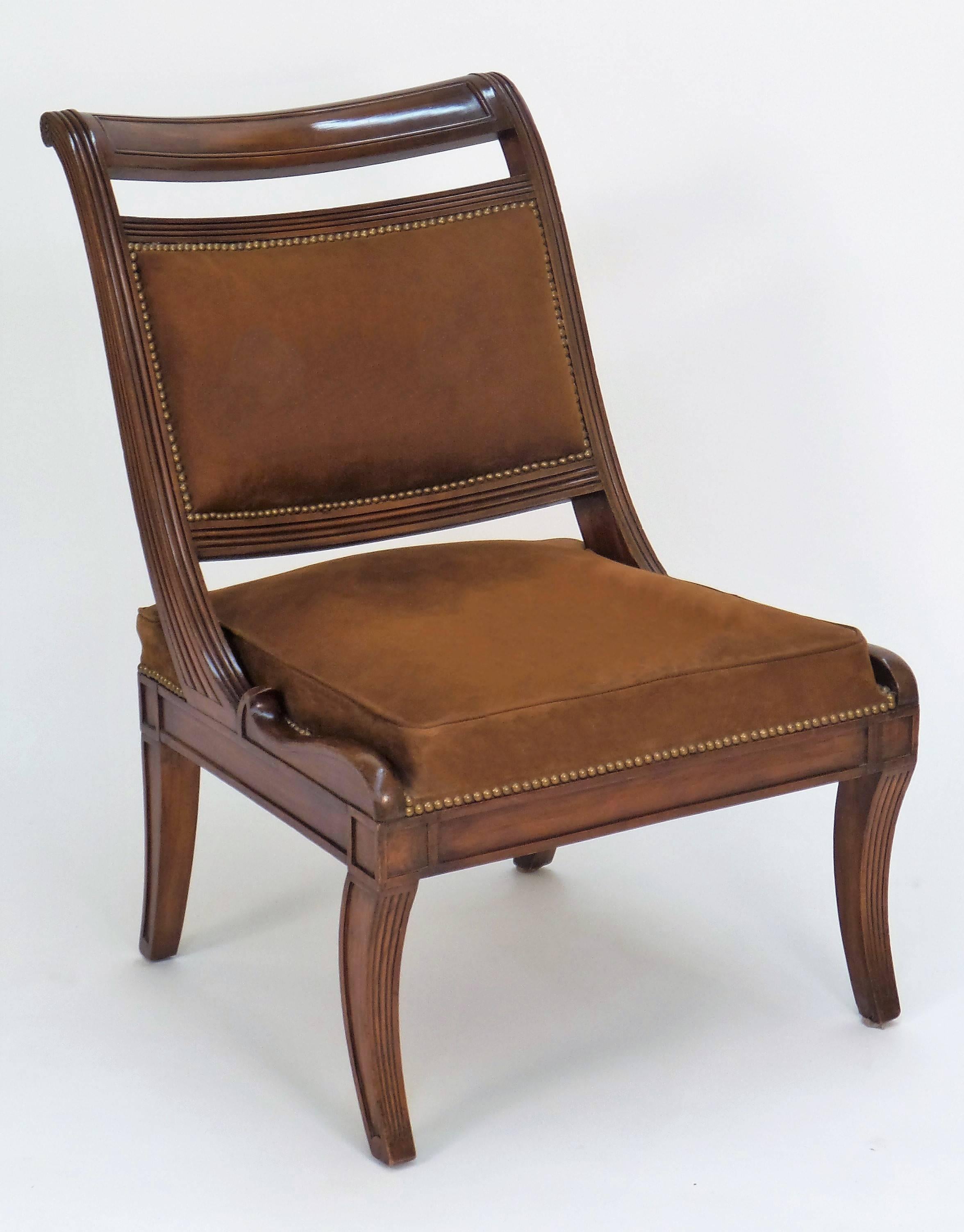 A Regency style chair inspired by Thomas Hope and Klismos style chairs, with a sweeping back and reeded frame details on sabre form feet and a boxed seat cushion. COM and custom finishes available.