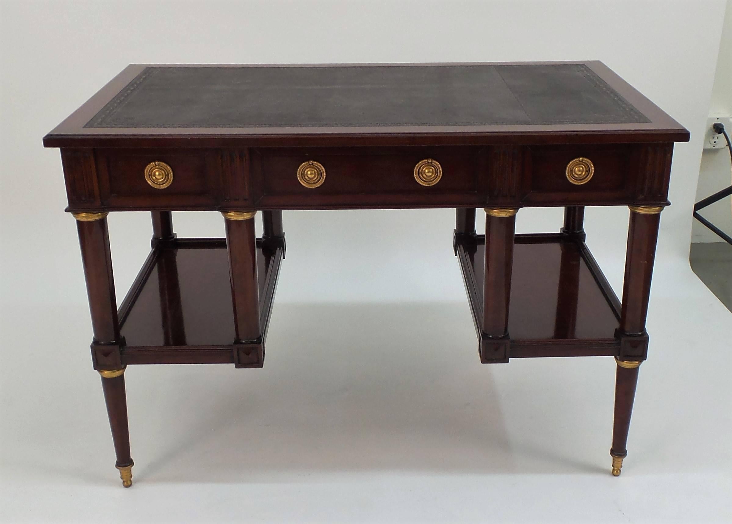 Victoria & Son's Rue du Cirque desk, made in the neoclassical style of Louis XVI with two easily accessible open shelves supported by four legs, with three drawers in the apron and faux-drawer faces on the opposite side. Shown with a blind tooled