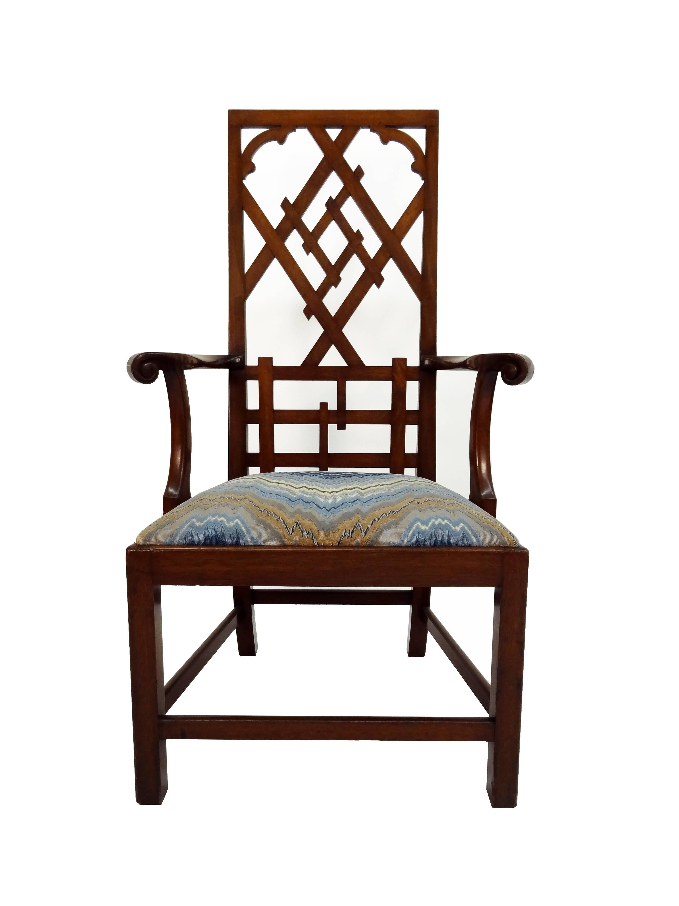 A Chippendale style open armchair with fret work high back and an upholstered drop-in seat. Seat upholstery can to customized. Total of four available. Please allow 4-6 weeks lead time.