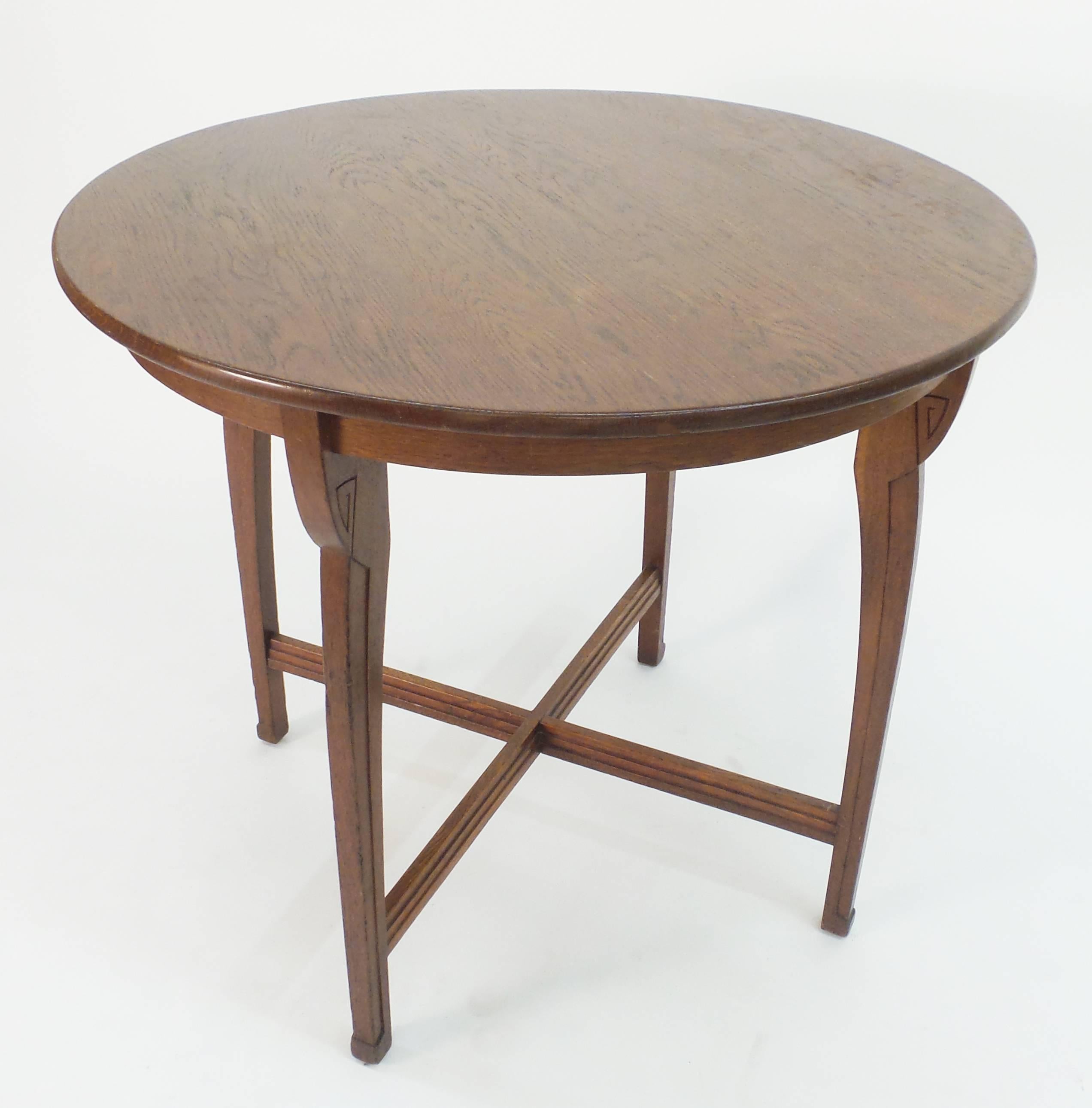 A German oak centre/side table, the design in the manner of Henry van de Velde and having a step molded stretcher unifying the legs.
