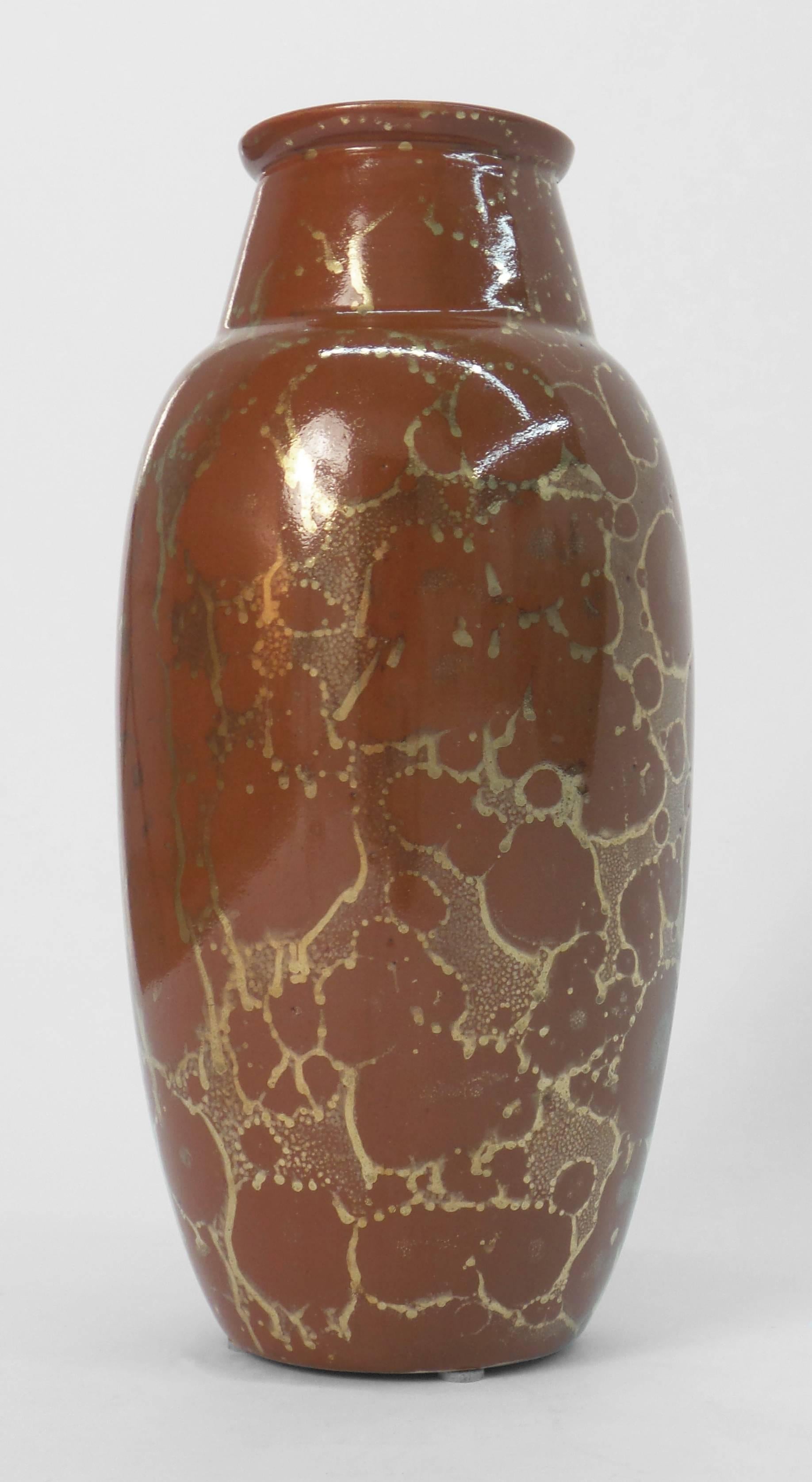 An Art Deco period hard stone vase having a brown glaze with gold décor. Made by Lucien Brisdoux (1878-1963). St. Amand, France, circa 1925. Signed.