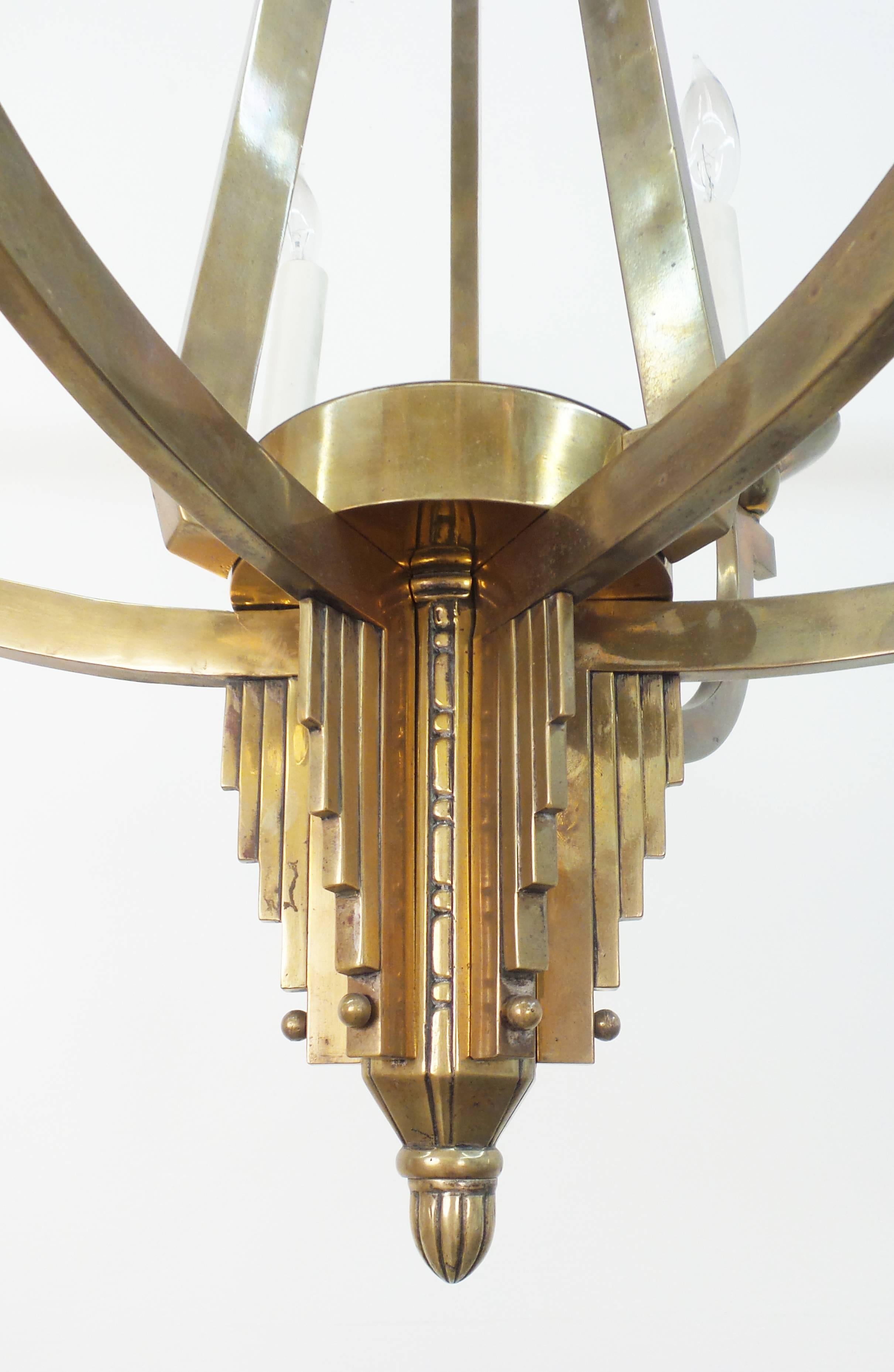 An Art Deco period six-light chandelier executed in brass, England, circa 1935.