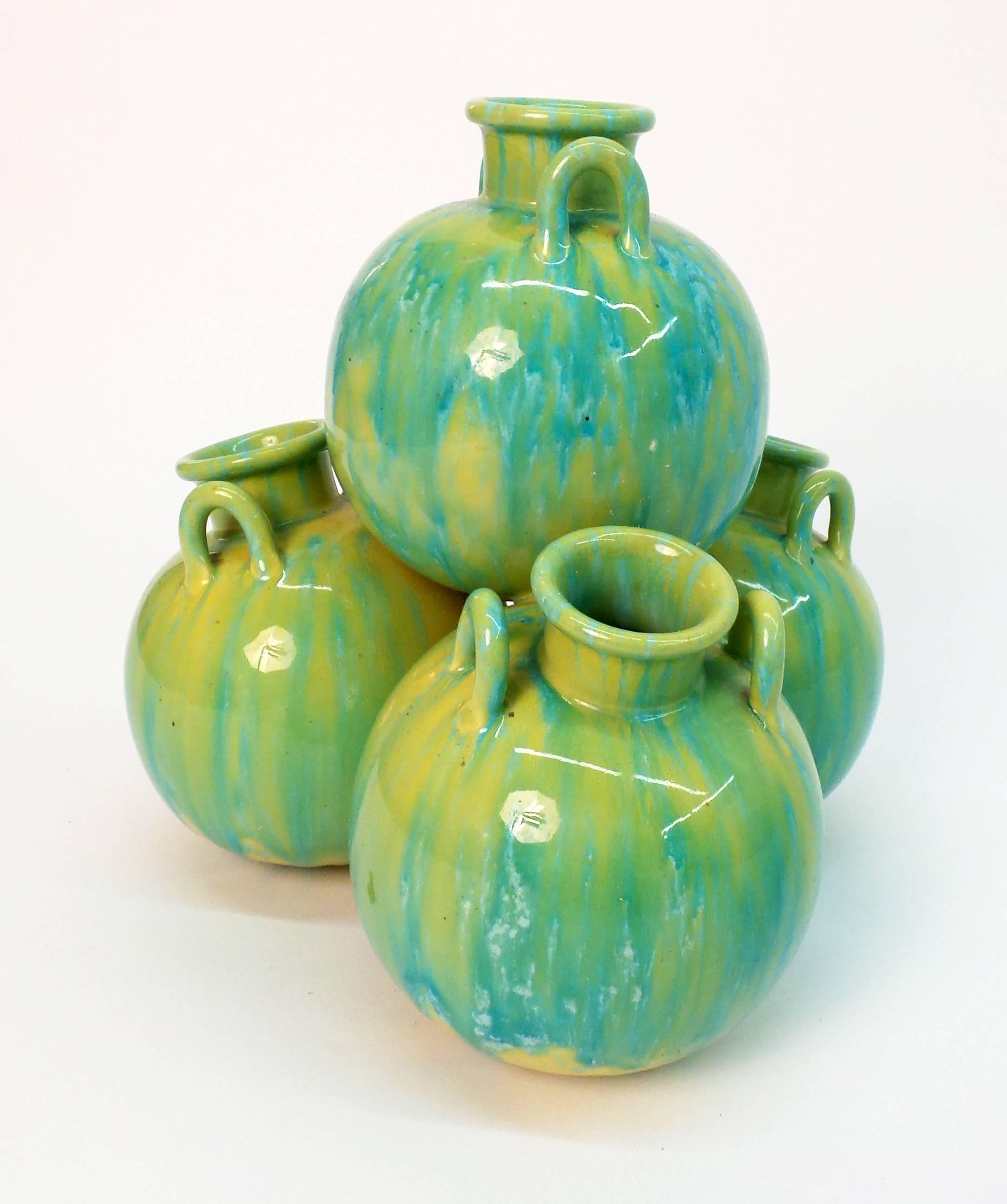 An unusual English Aesthetic period pottery vase of pyramidal form and based on a model by Minton's, composed by a stack of four melon form vases with handles, circa 1895.