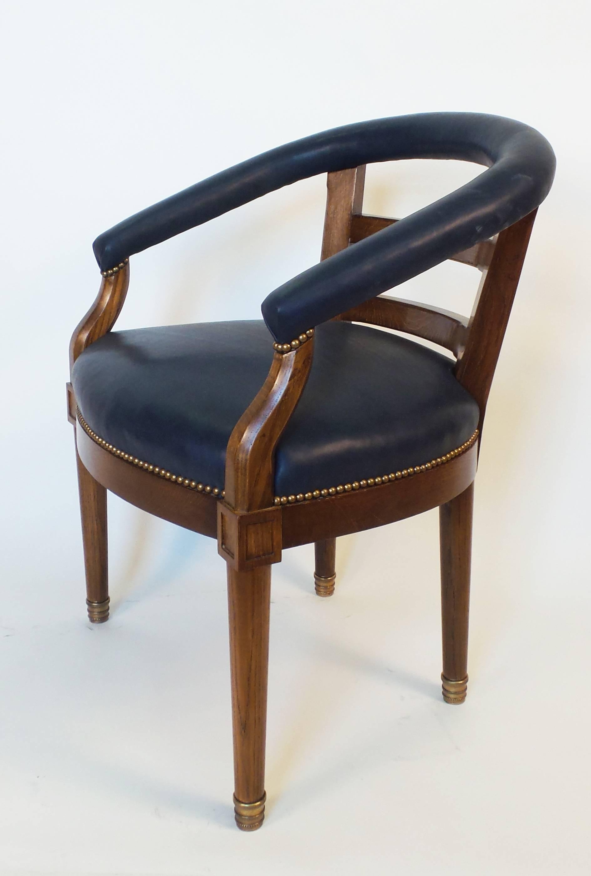 The American barrel-back armchair is an updated approach to early 20th century barrel back chairs. The back of the chair has been angled to better support both the back and arms of the user and the frame is crafted from durable white oak. Arms are