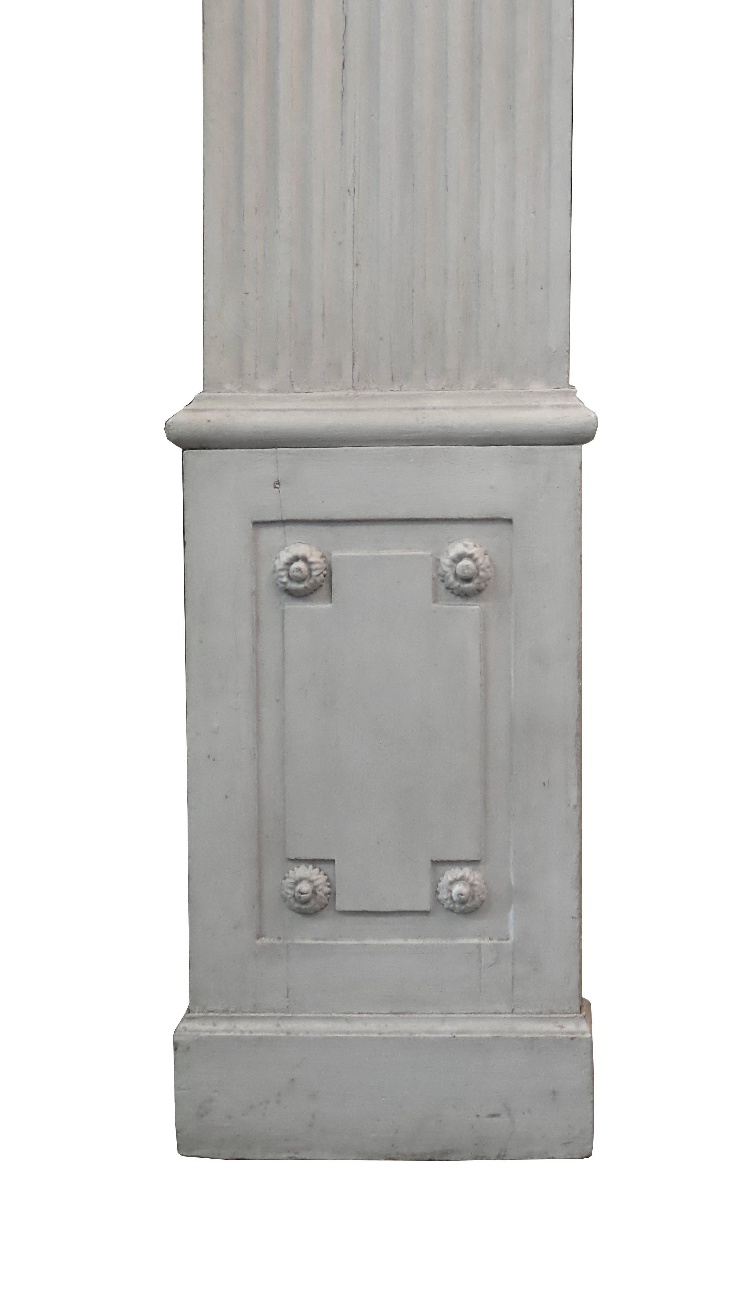 A set of six antique 19th century Louis XVI style fluted pilasters capped with Ionic capitals, lovely chalky grey-white finish, five of which measure 16" wide at the base and one narrower at 13" wide.
