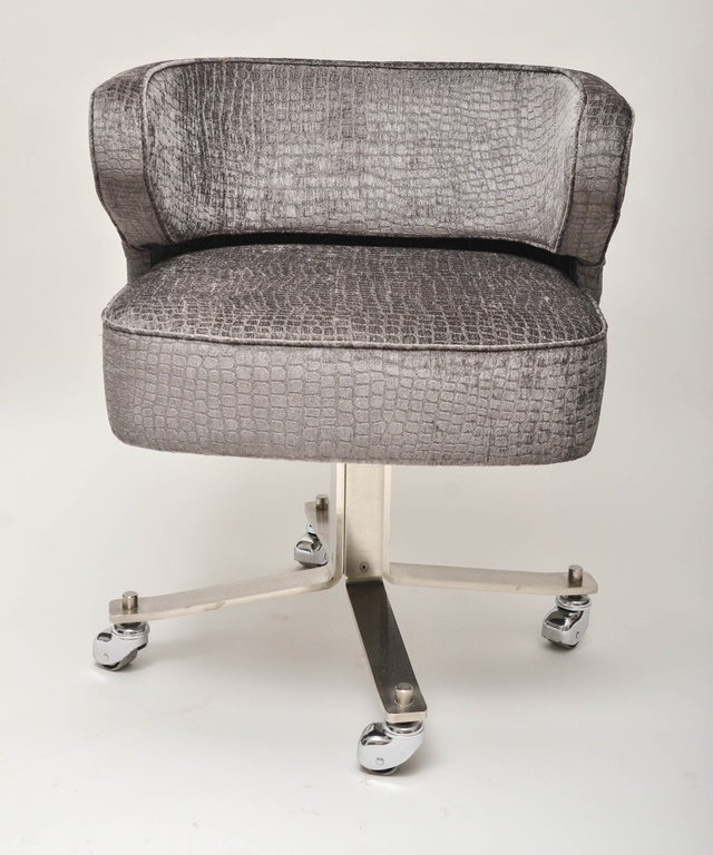 Chrome upholstered rolling desk chair.