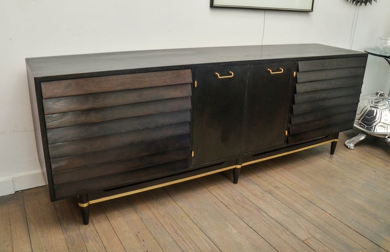 Wood credenza with brass details, with six exterior and three Interior drawers.