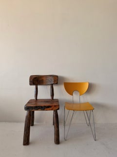 Primitive hand-carved sculptural wood chairs with live edges