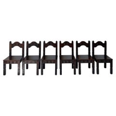 Set of six hand-carved dark-stained wood dining chairs with chevron motifs