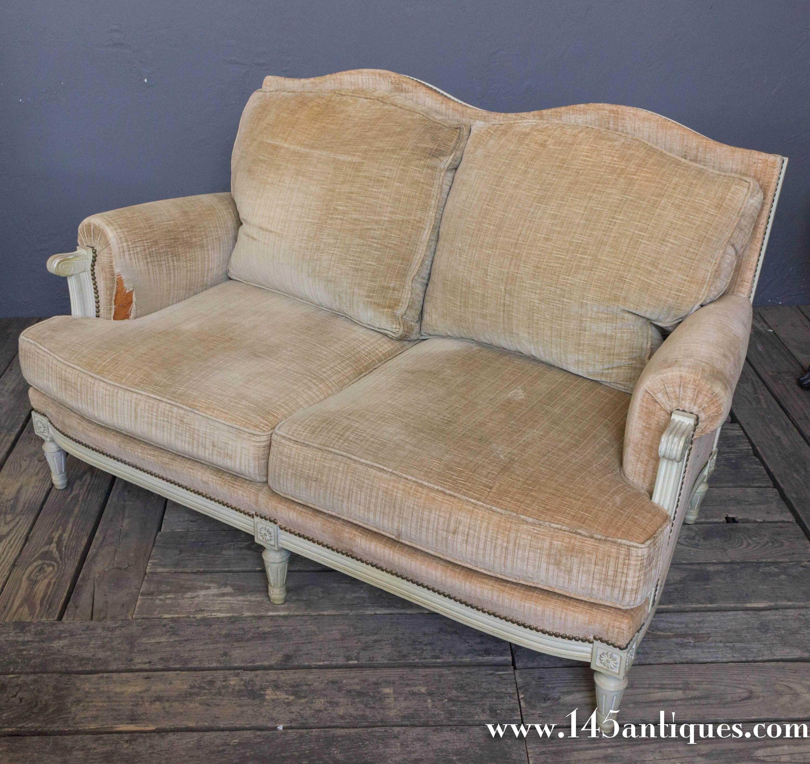 French 1950s Louis XVI style settee with white painted wood trim and faded tan velvet. This piece has two cushions.