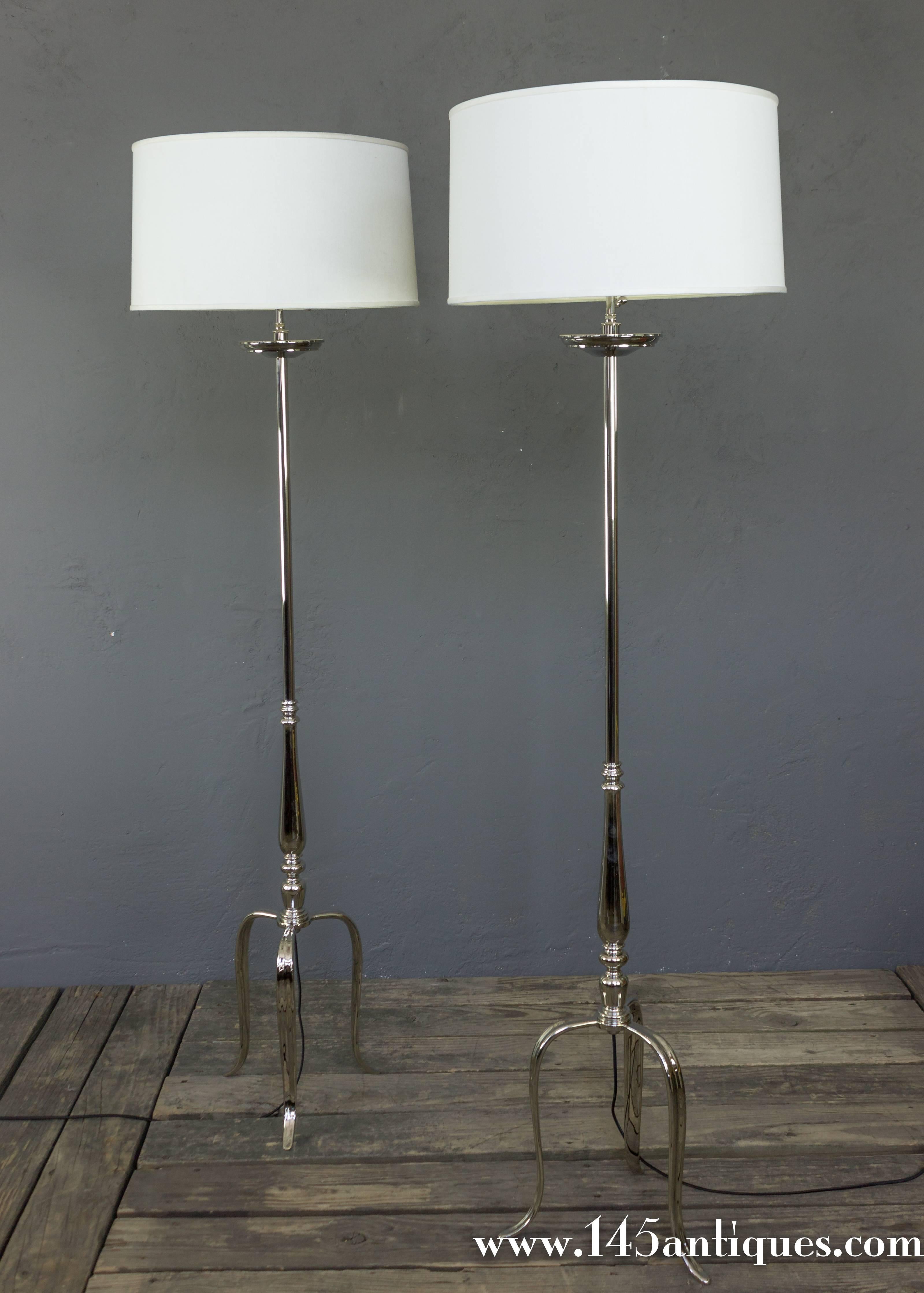 Very elegant pair turned and cast brass floor lamps on a tripod base. Recently plated in a polished nickel. New wiring, not UL code.