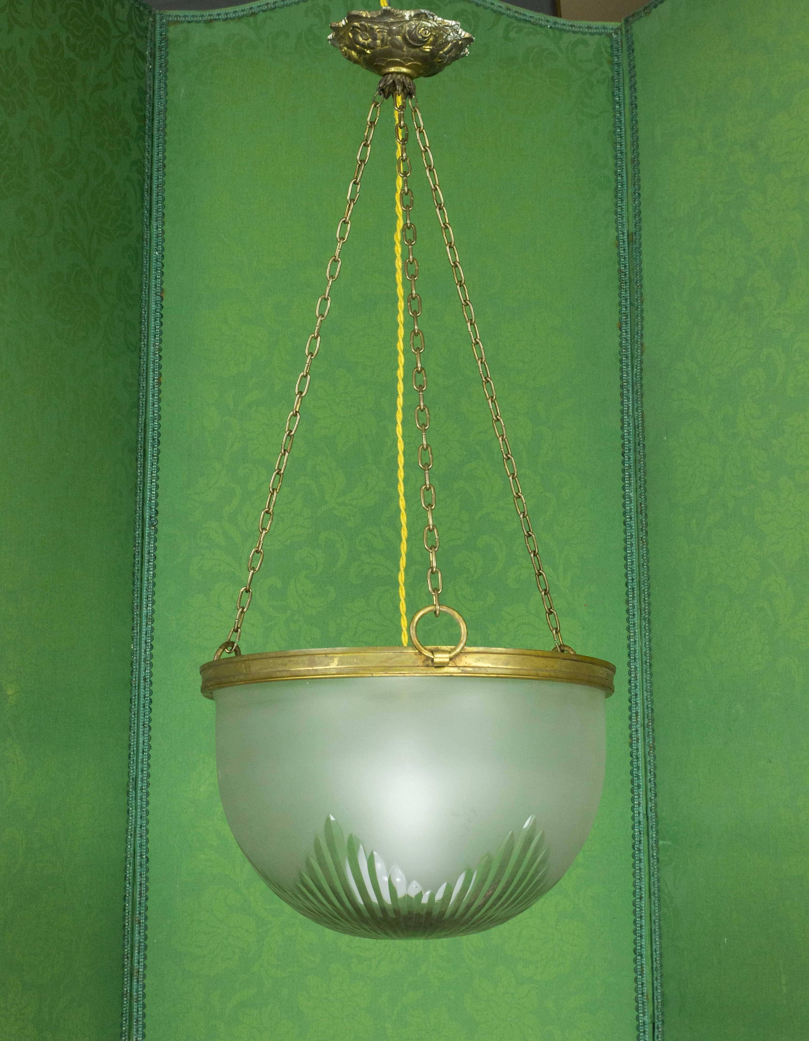 An unusual French light fixture, the cut-glass and frosted globe is suspended by three adjustable chains, circa 1920s.