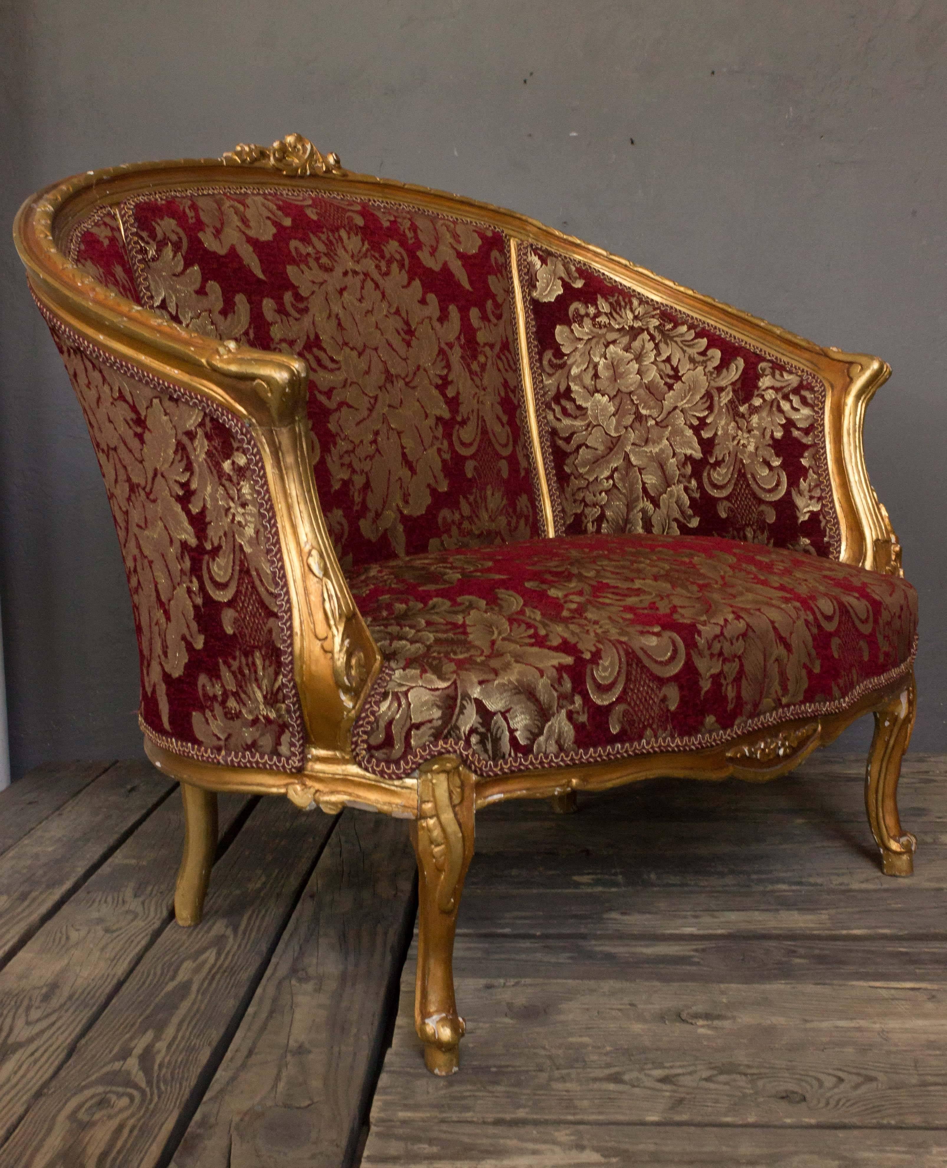 A very elaborate gilt marquise or wide bergère. This one-of-a-kind gilt Rococo style marquise is a must-have for any luxury living room, bedroom or home space. Few pieces capture the lush style of Italian design like this very elaborate armchair.