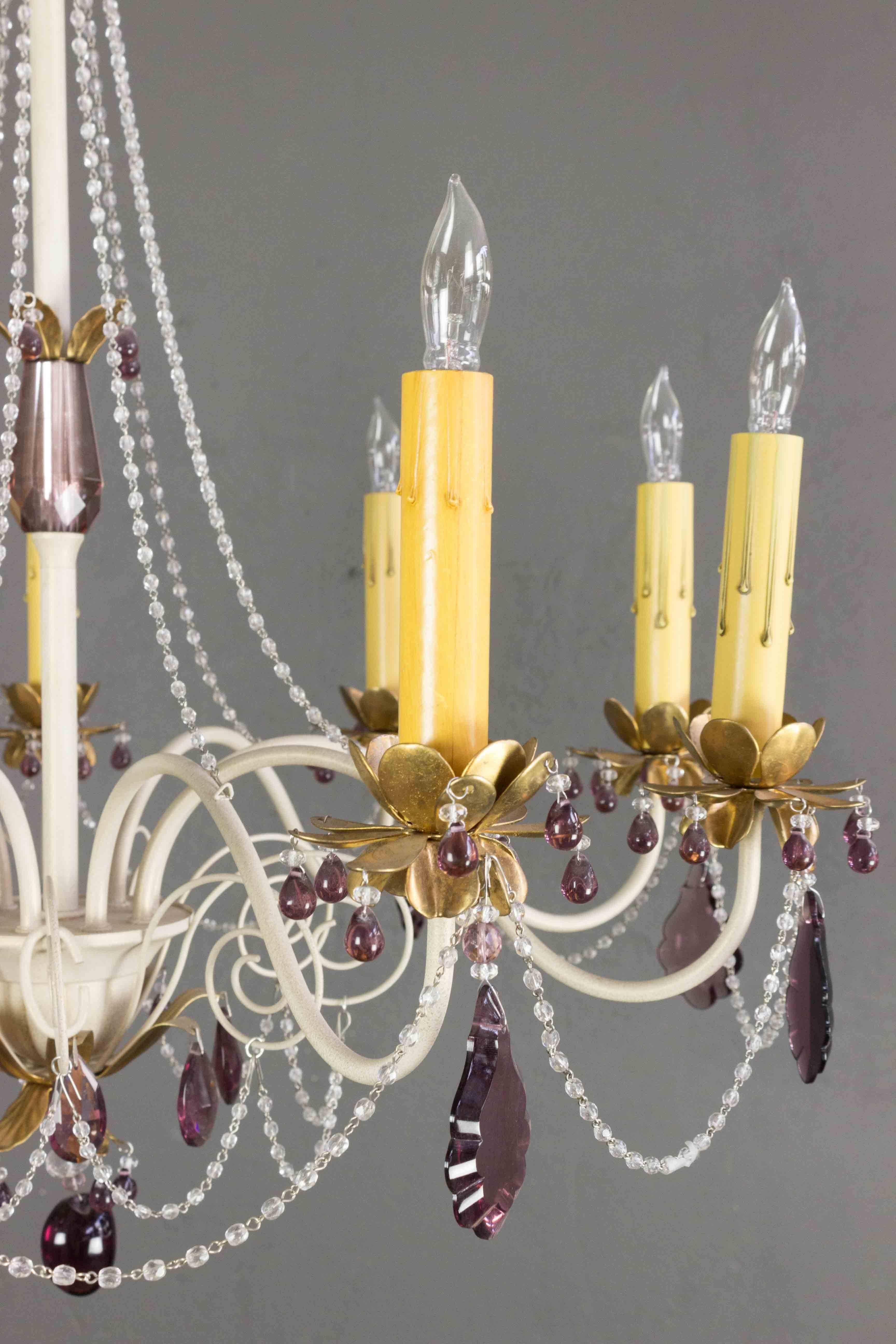 Presenting a stunning French 1960s painted white metal chandelier with nine arms and beautiful amethyst colored glass decorations. Complete with a matching canopy and chain, this chandelier has been wired according to UL standards, ensuring ease of