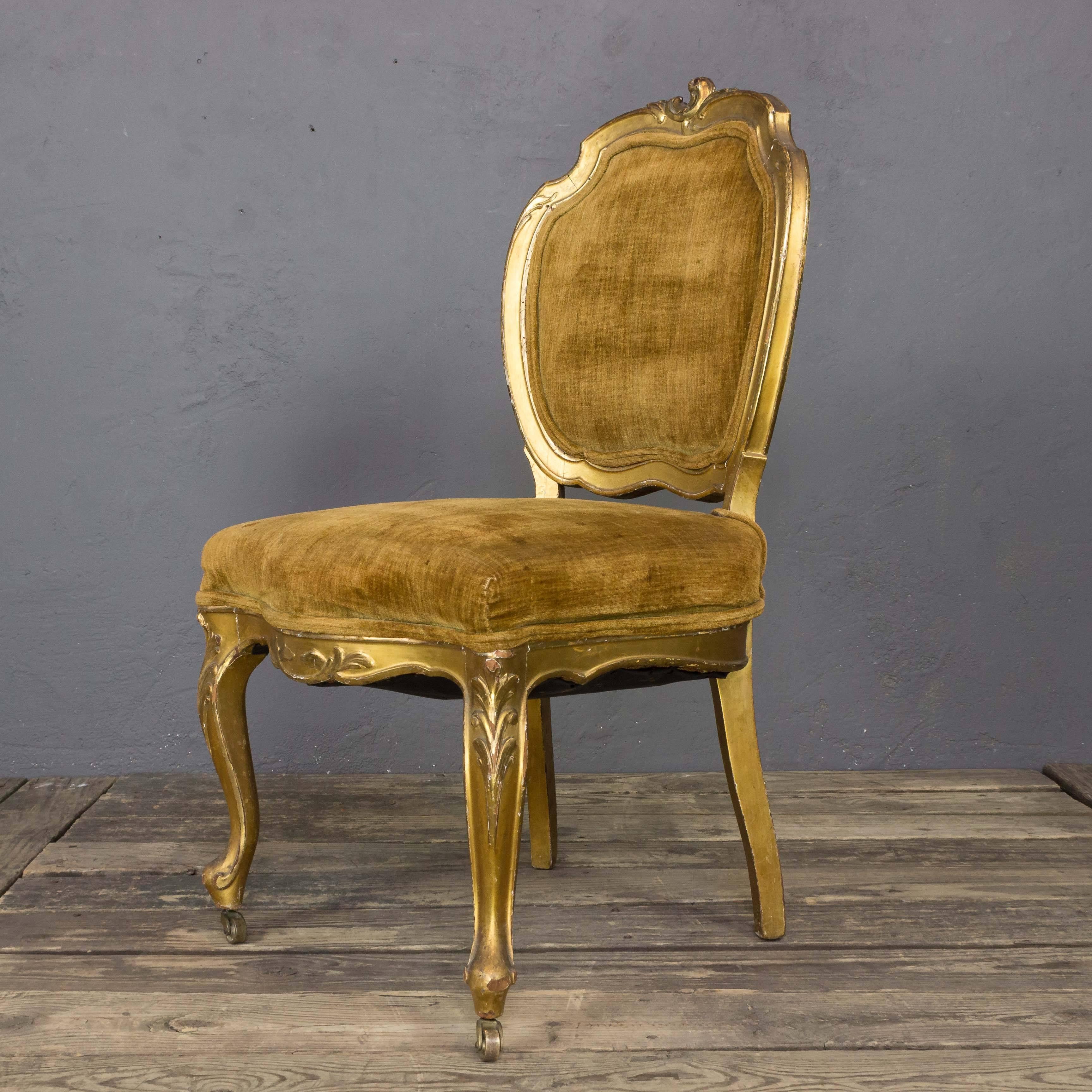 Pair of French 19th century giltwood side chairs with distressed brown upholstery. The gilding is original and shows a beautiful aged patina. The chairs need to be upholstered. Sold as is. Upholstery services available, price on request.

