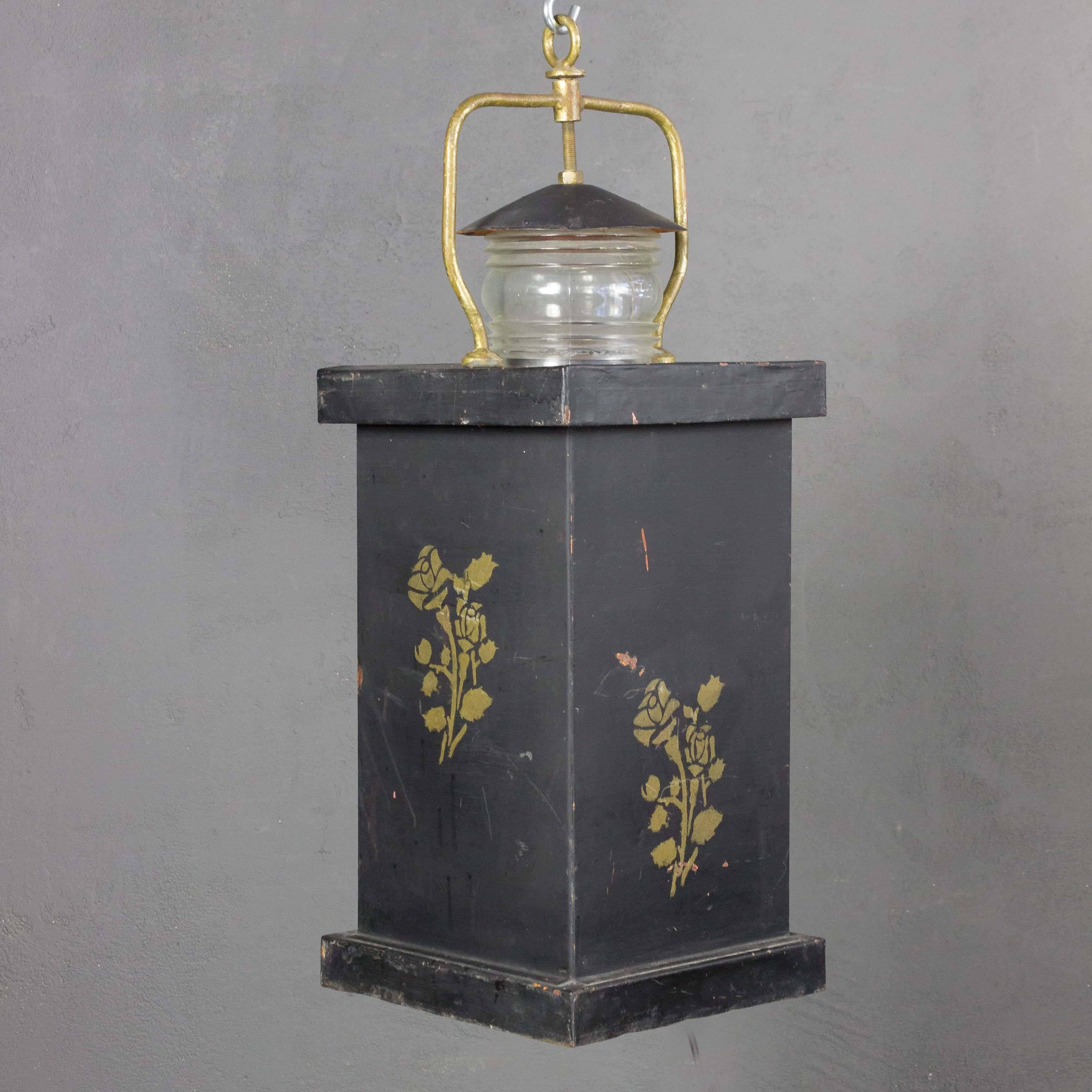 An unusual pair of French barge lanterns in black tole with applied rose designs, early 20th century.