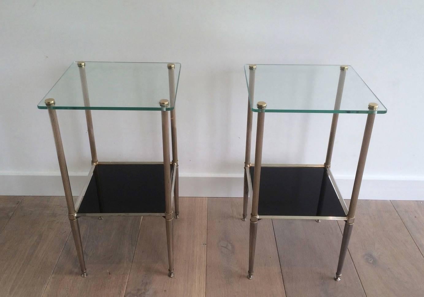 A nice pair of end tables with silvered brass legs. The top shelves are clear glass and the bottom shelves are black mirror, French, 1950s.

These tables are currently in France, please allow 2 to 4 weeks delivery to New York. Shipping costs from