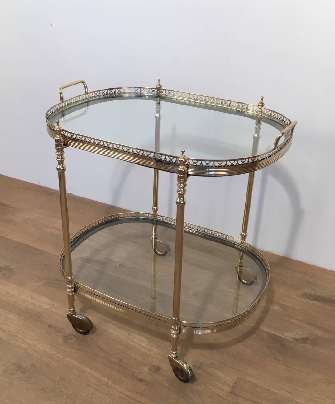 Oval fine bar cart in brass with a steel part under the two trays. Both trays can be removed. French, circa 1940 

This item is currently in France, please allow 2 to 4 weeks delivery to New York. Shipping costs from France to our warehouse in New