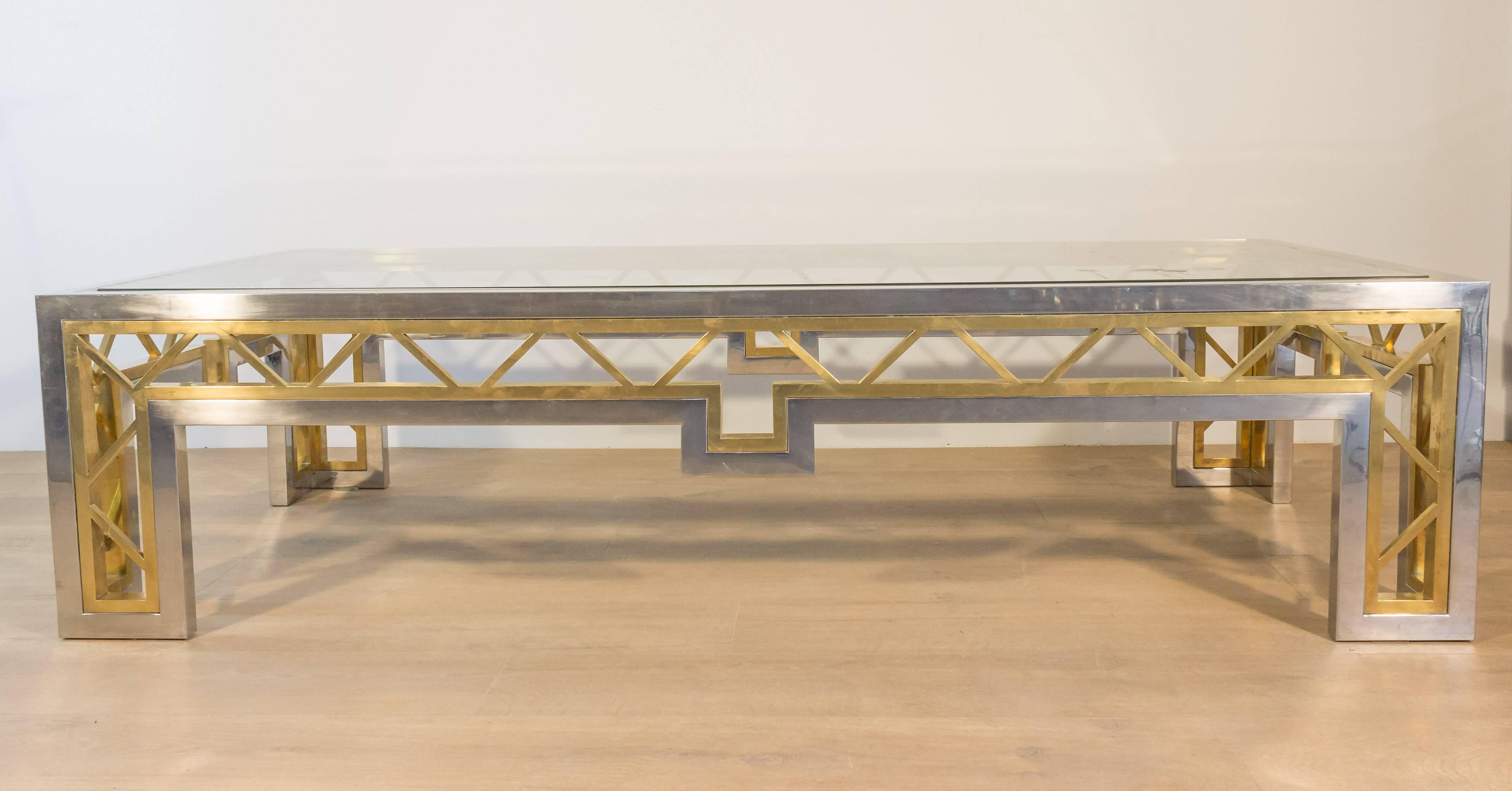 Large polished steel coffee table with brass inset design. This table has a glass top, French, 1970s


His item is currently in France, please allow 2 to 4 weeks delivery to New York. Shipping costs from France to our warehouse in New York