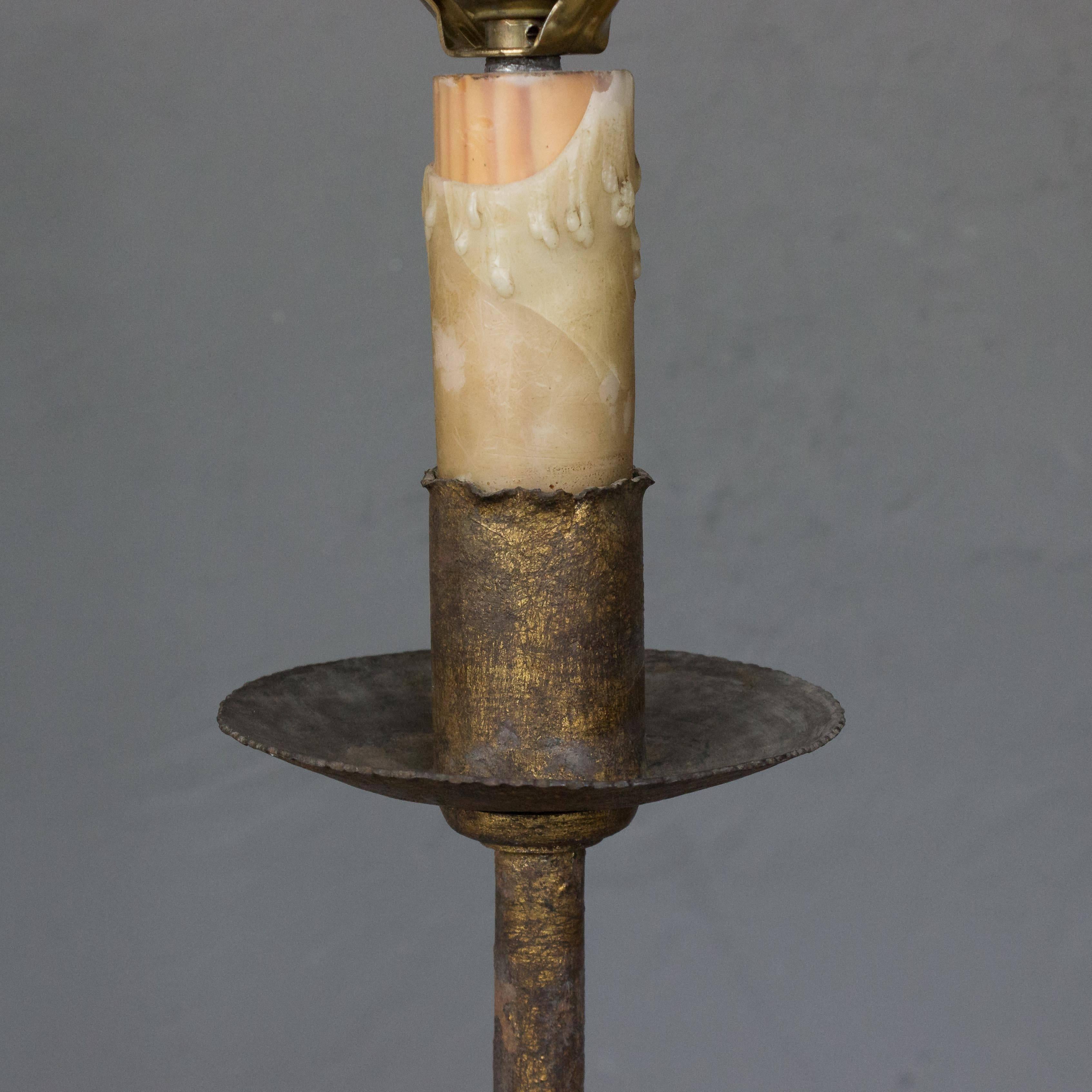 1950s rustique style wrought iron floor lamp on a graceful tripod base from Spain. The floor lamp has the original patina and has been recently rewired.
 