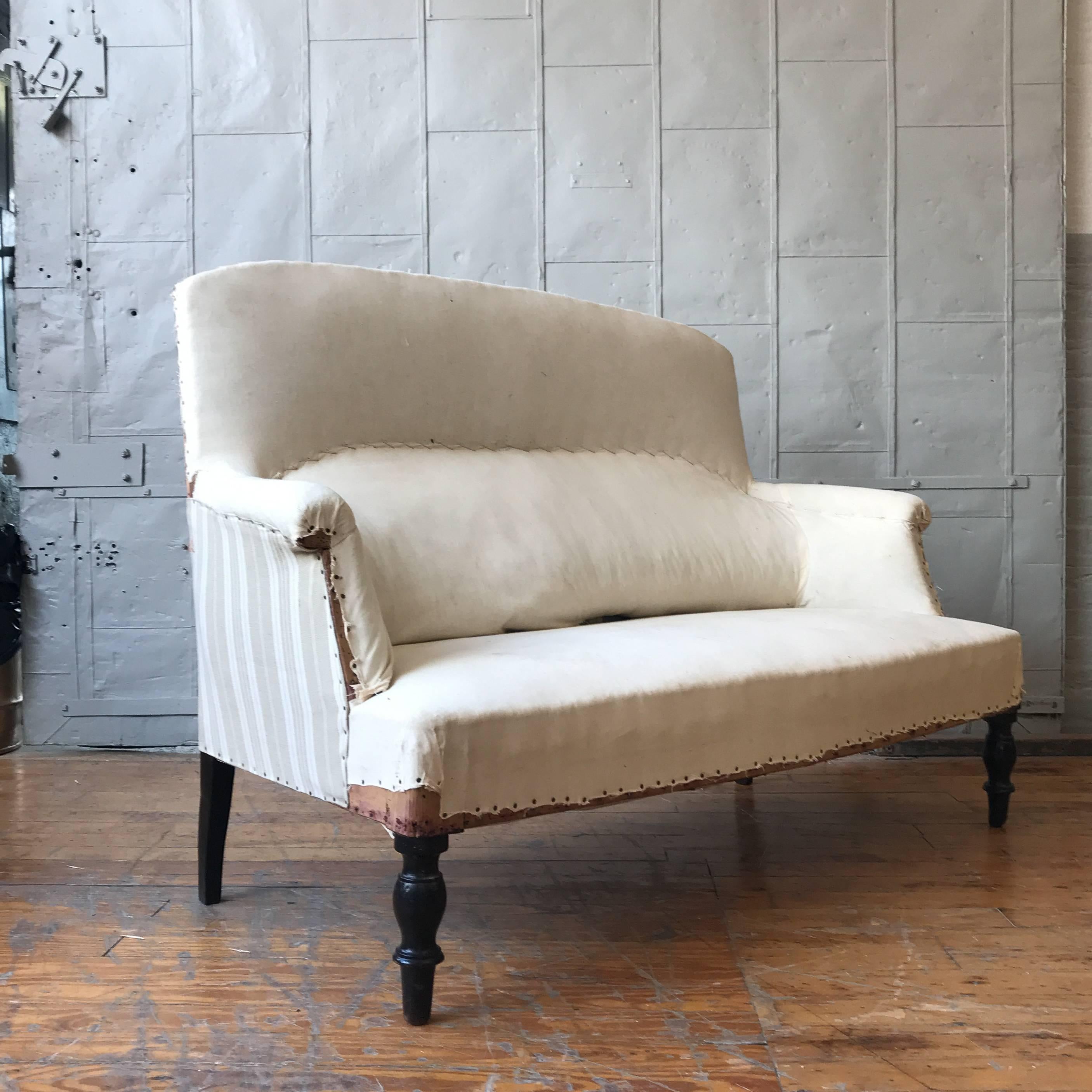Small French NAP III high back loveseat in muslin, circa 1900. Sold as is. Upholstery services available, price on request. 

  