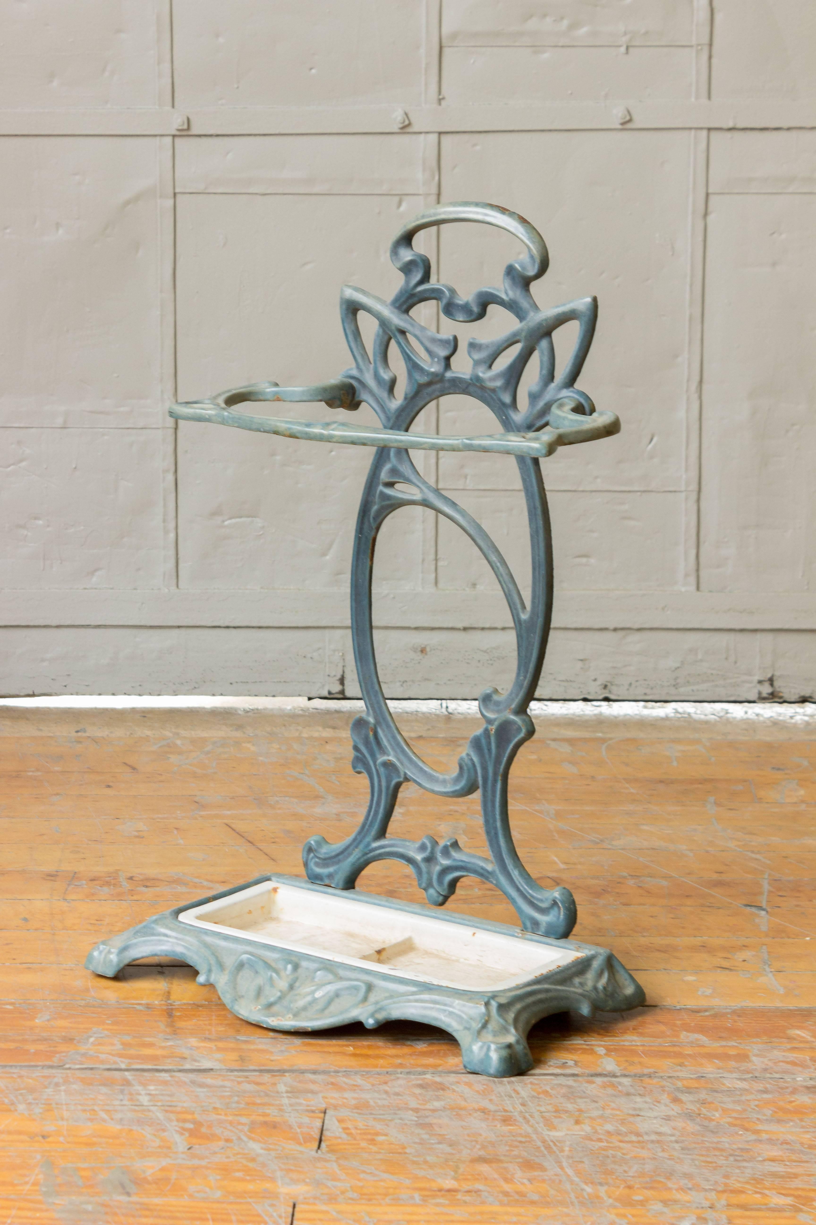 An enameled iron umbrella stand in the Art Nouveau style with a removable tray, French, circa 1920.