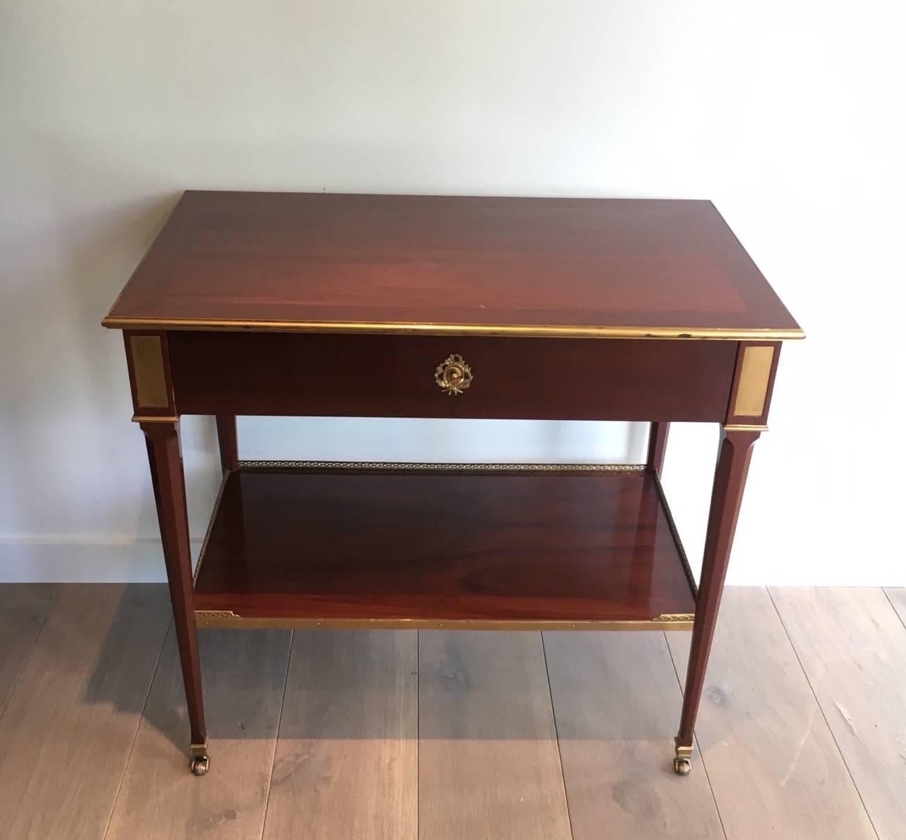 Jansen style Mahogany and brass console able; French, circa 1960.

This piece is currently in France, please allow 4 to 6 weeks for delivery. Shipping to our warehouse in New York is included in the price. 
  