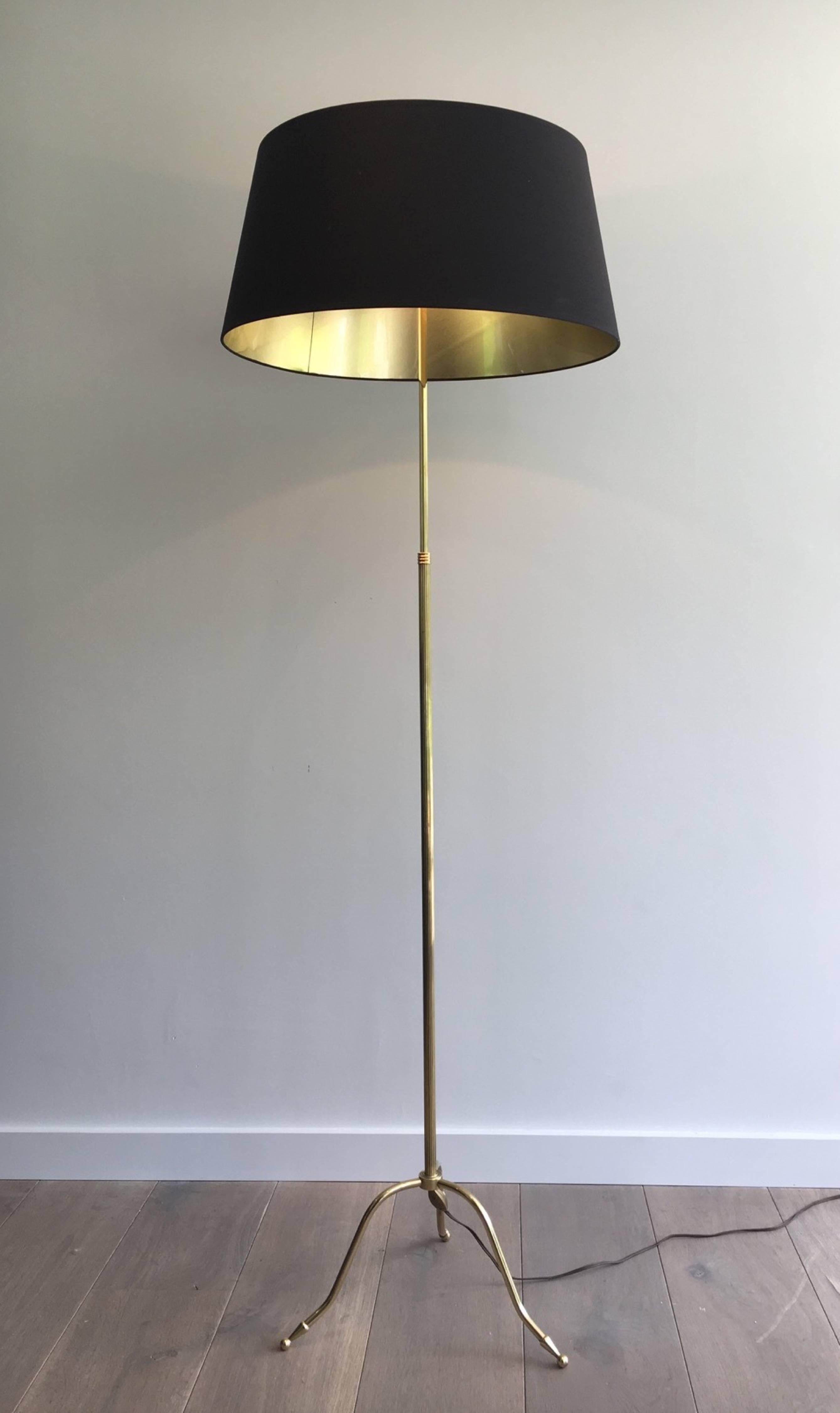 1940s French Maison Jansen style floor lamp with tripod base and gold lined shade.

This piece is currently in France, please allow 4 to 6 weeks for delivery. Shipping to our warehouse in Long Island City, New York is included in the price.
