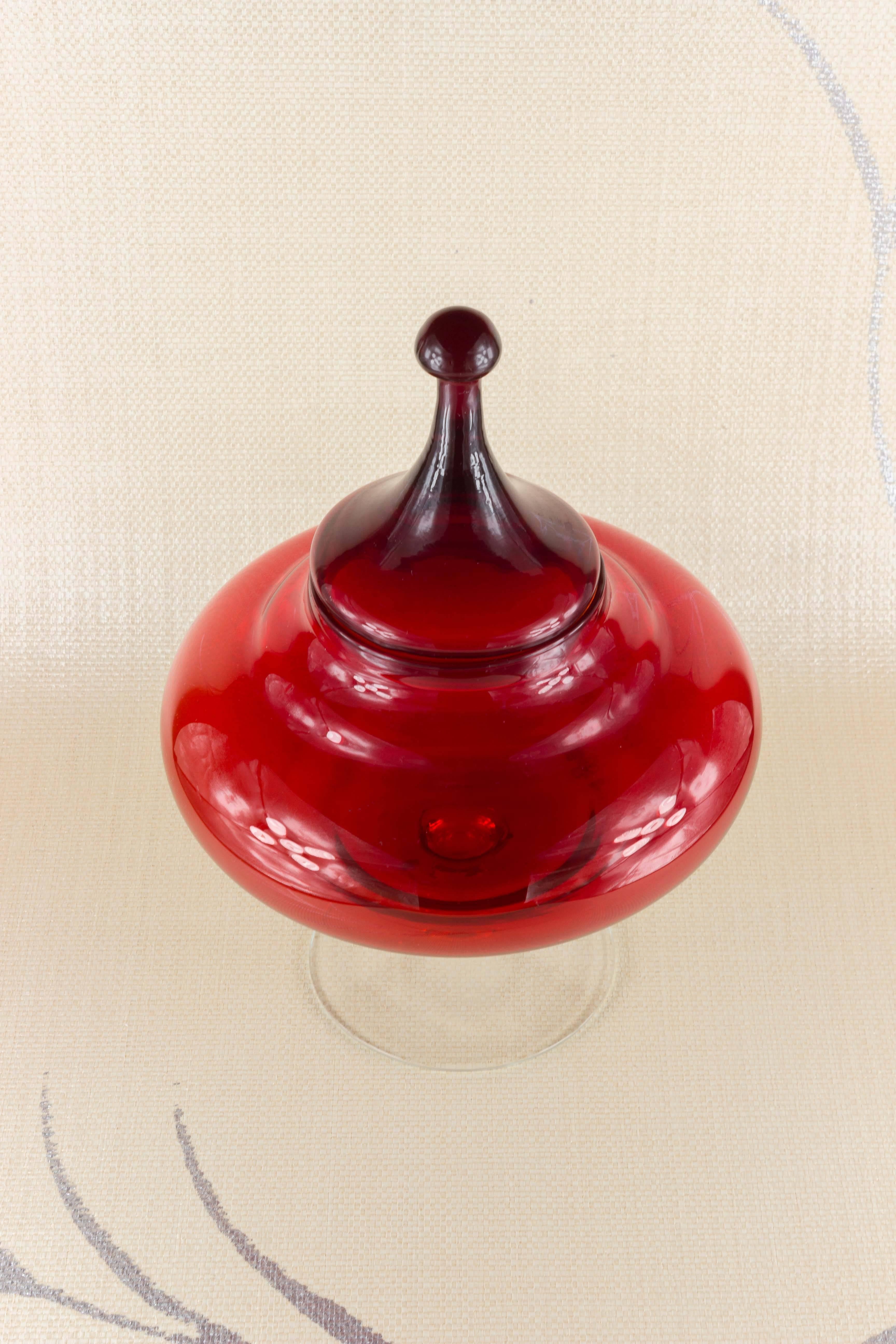 Red dish with matching lid mounted on a clear base. In the style of Empoli in Italy, circa 1950s.