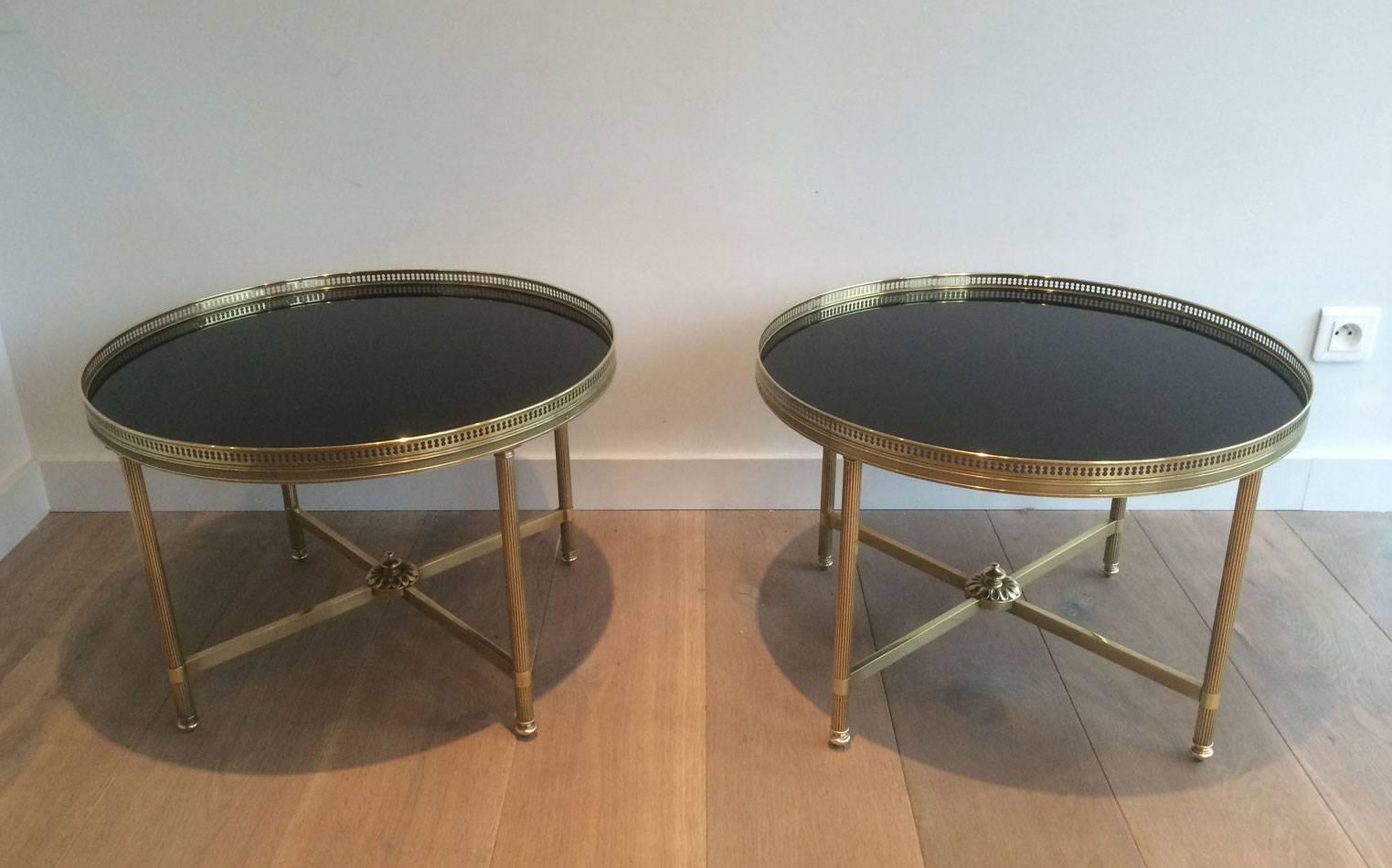 Pair of round brass end tables with black glass tops by Maison Jansen

These pieces are currently in France, please allow 4 to 6 weeks for delivery. Shipping to our warehouse in Long Island City, New York is included in the price.