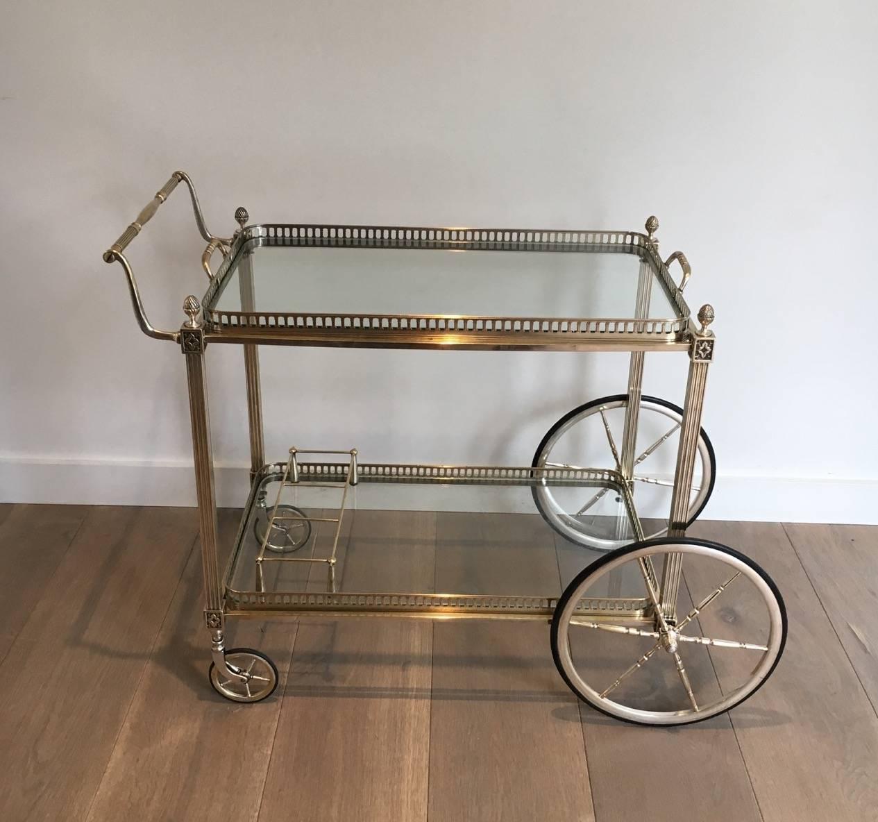 A French bar cart in silvered brass. The top shelf is removable and the bottom shelf has a bottle rack, circa 1940s

This bar cart is currently in France, please allow 2 to 4 weeks delivery to New York. Shipping costs from France to our warehouse