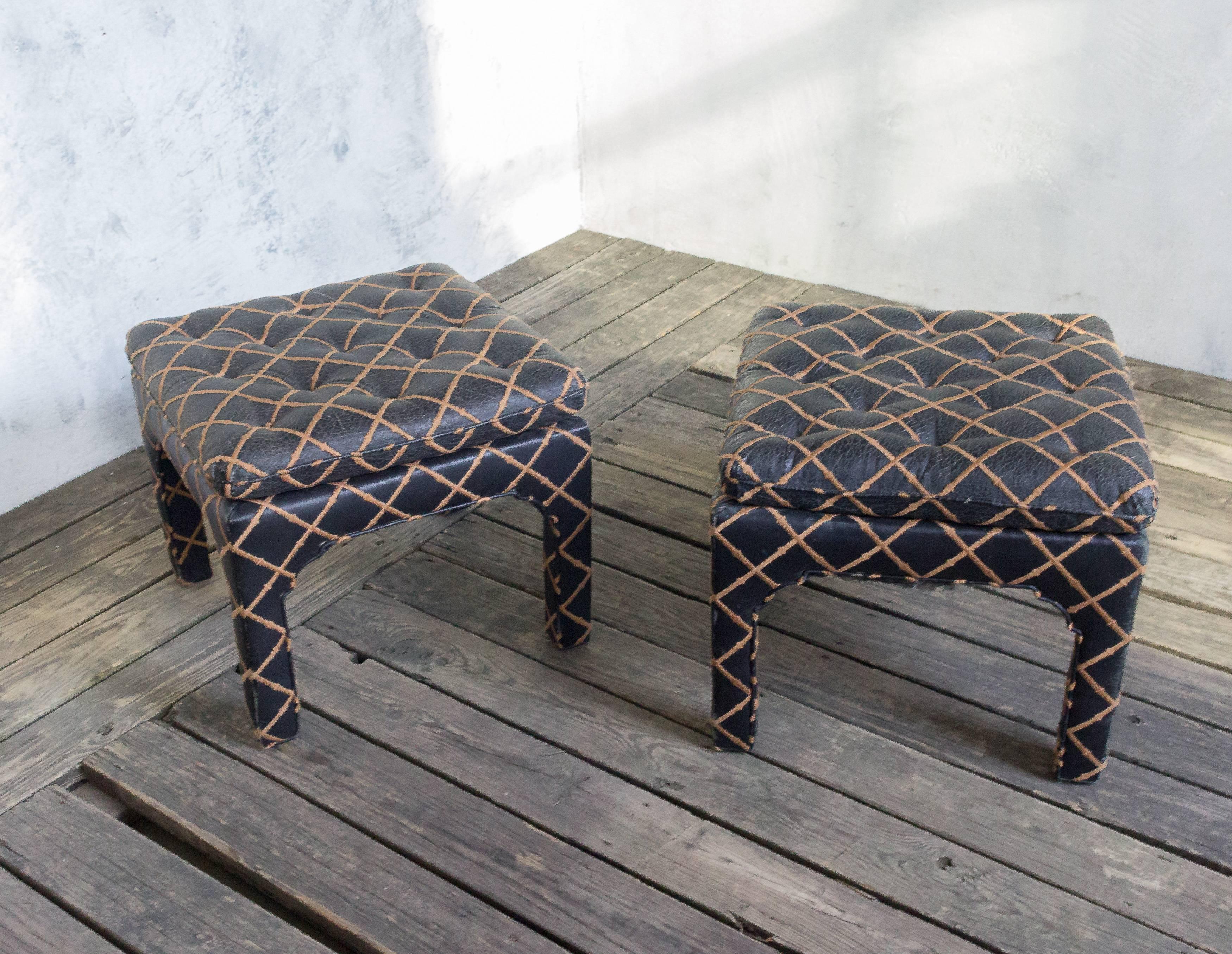 A unique pair of tufted square benches upholstered in embroidered black leather. Add a timeless touch of sophistication to any space with this incredible pair of tufted square benches. Upholstered in beautiful embroidered black leather with a bamboo