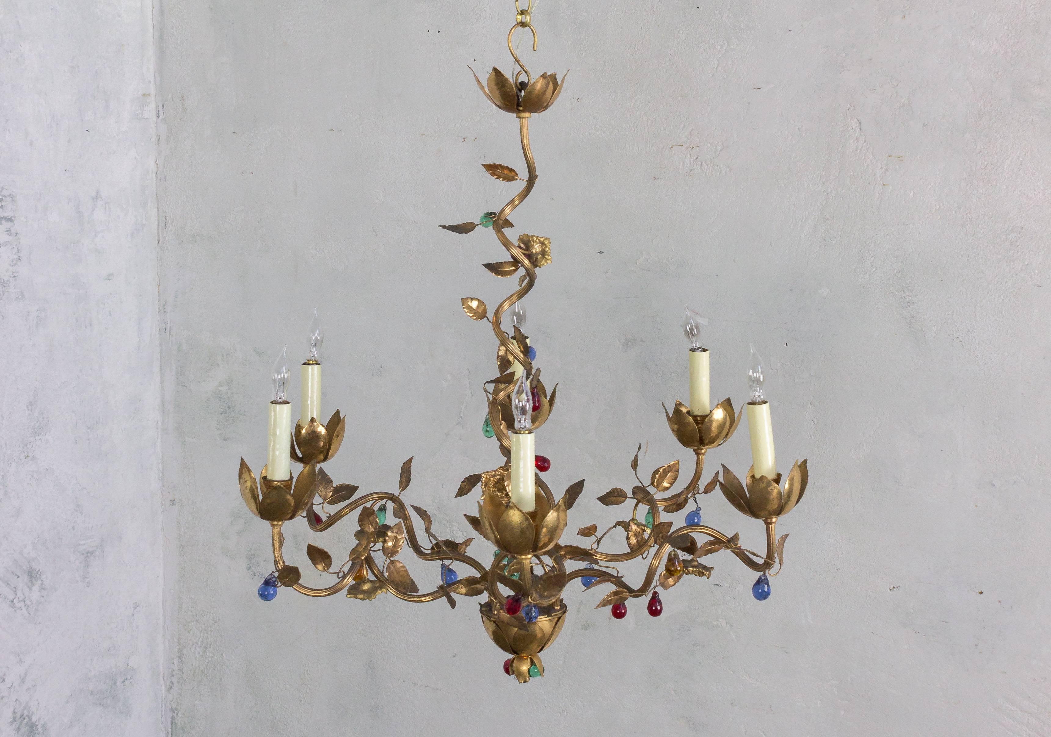 Presenting a remarkable Spanish 1960s gilt metal six-armed chandelier, featuring colored glass accents and intricately designed leaves. This exceptional piece is in very good vintage condition and has been recently rewired, although it is not UL