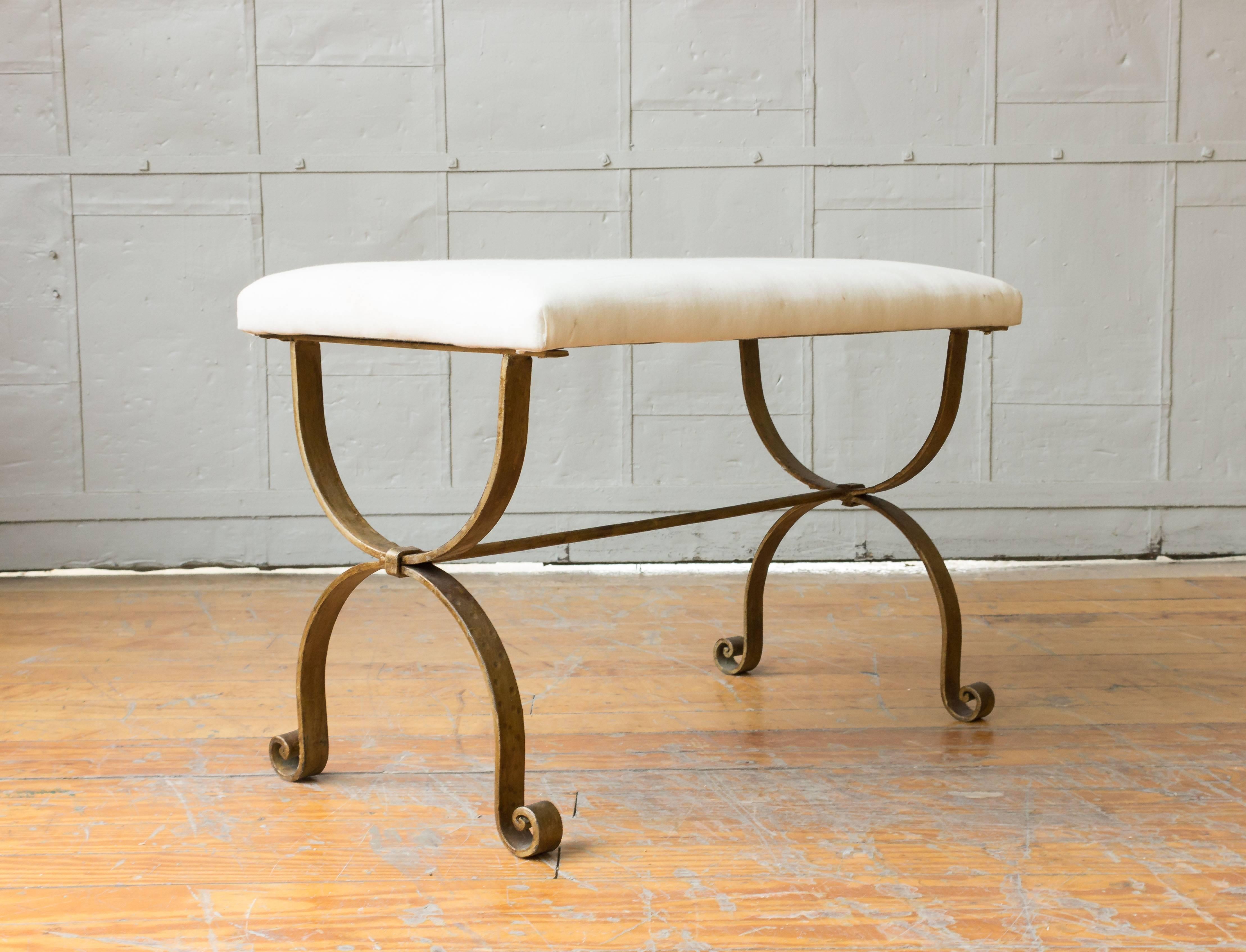 Spanish gilt iron bench with scrolled legs and upholstered in muslin, circa 1950s.

 