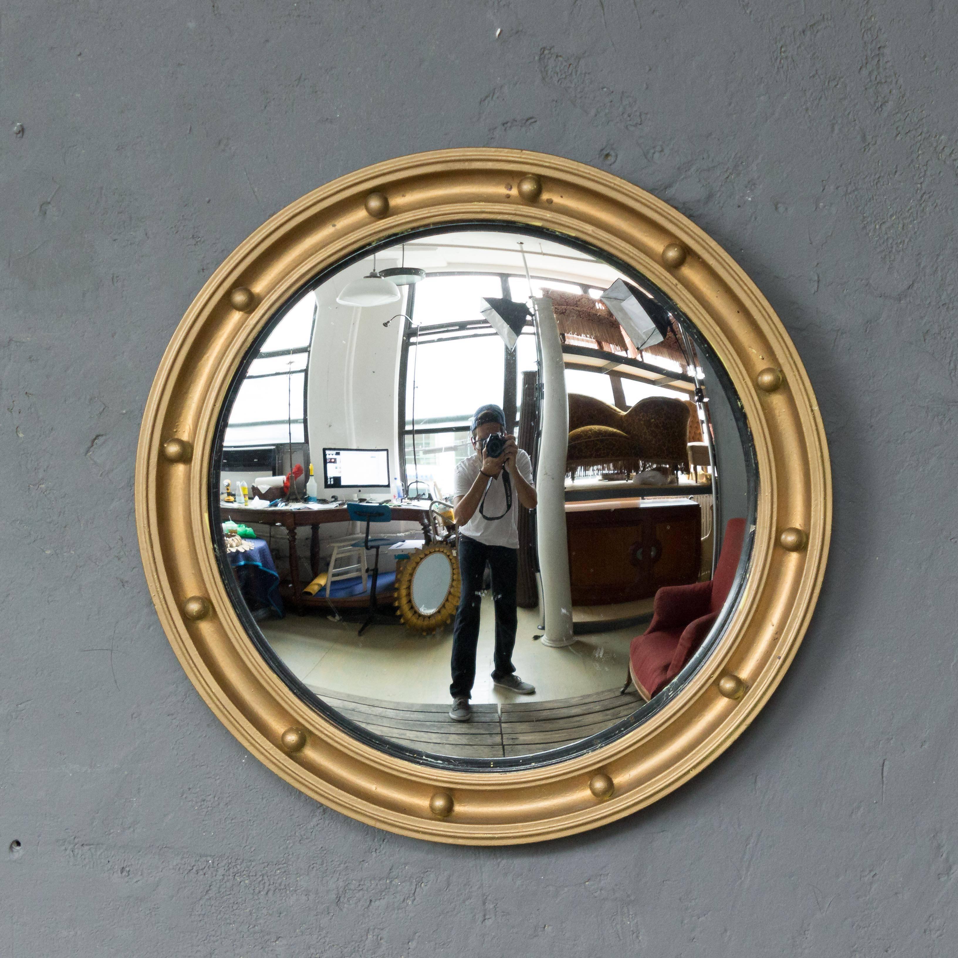 Small convex bullseye mirror with painted frame. The mirror is original with age shown with light fading and minor marks.