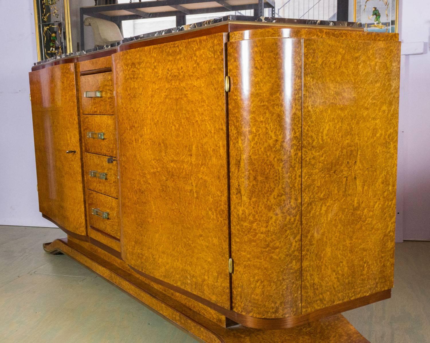 French Art Deco style elm burl sideboard with original black and gold marble. Brass trim around the inset marble and also along the base of the sideboard. The drawer's pulls are original glass. The price includes having new shelves made.

The