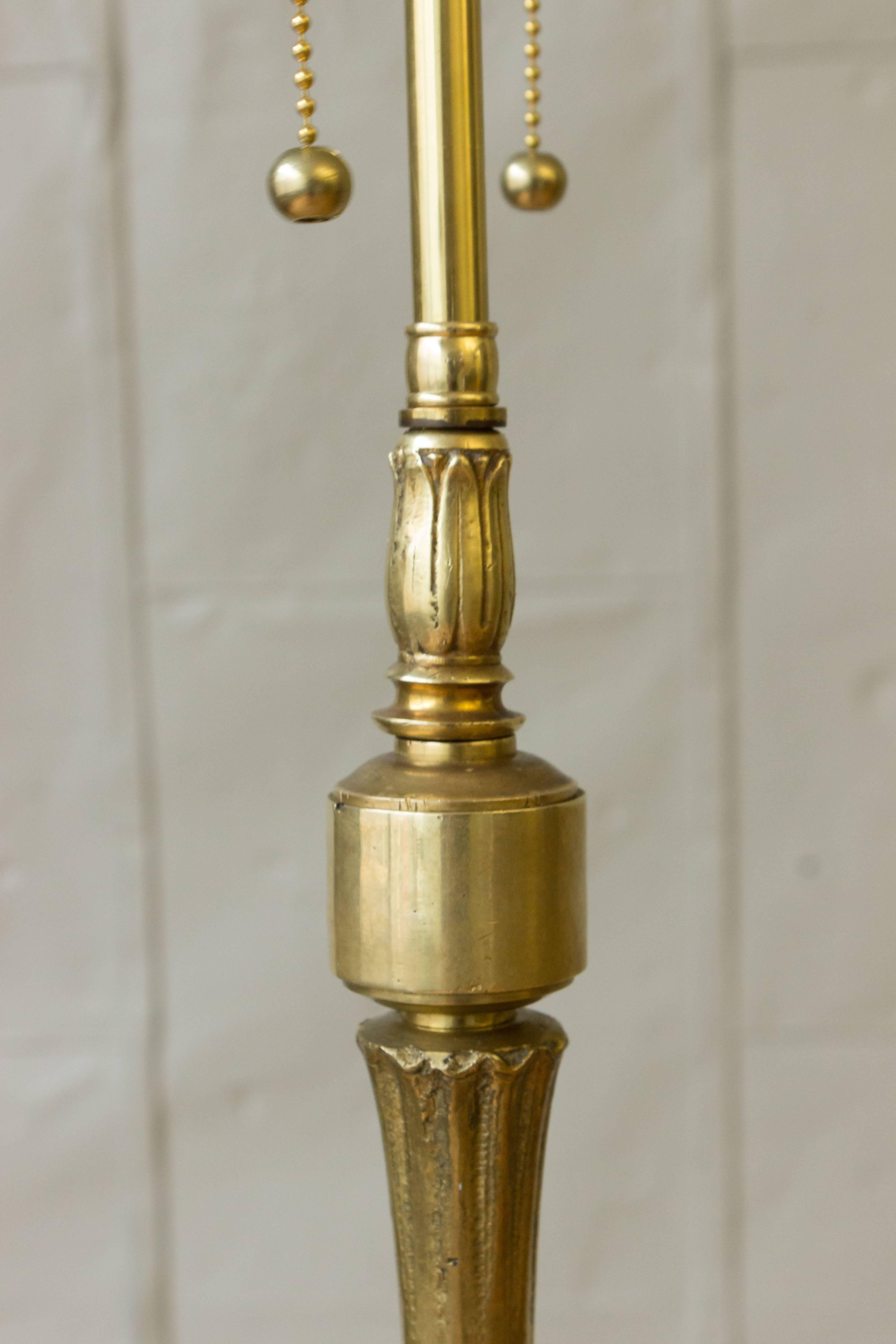 Very good quality bronze and brass floor lamp in the Neoclassical style. The floor lamp is composed of several turned or cast components and is mounted on a tripod base. 

Recently rewired with a double cluster. Not sold with shade.

French,