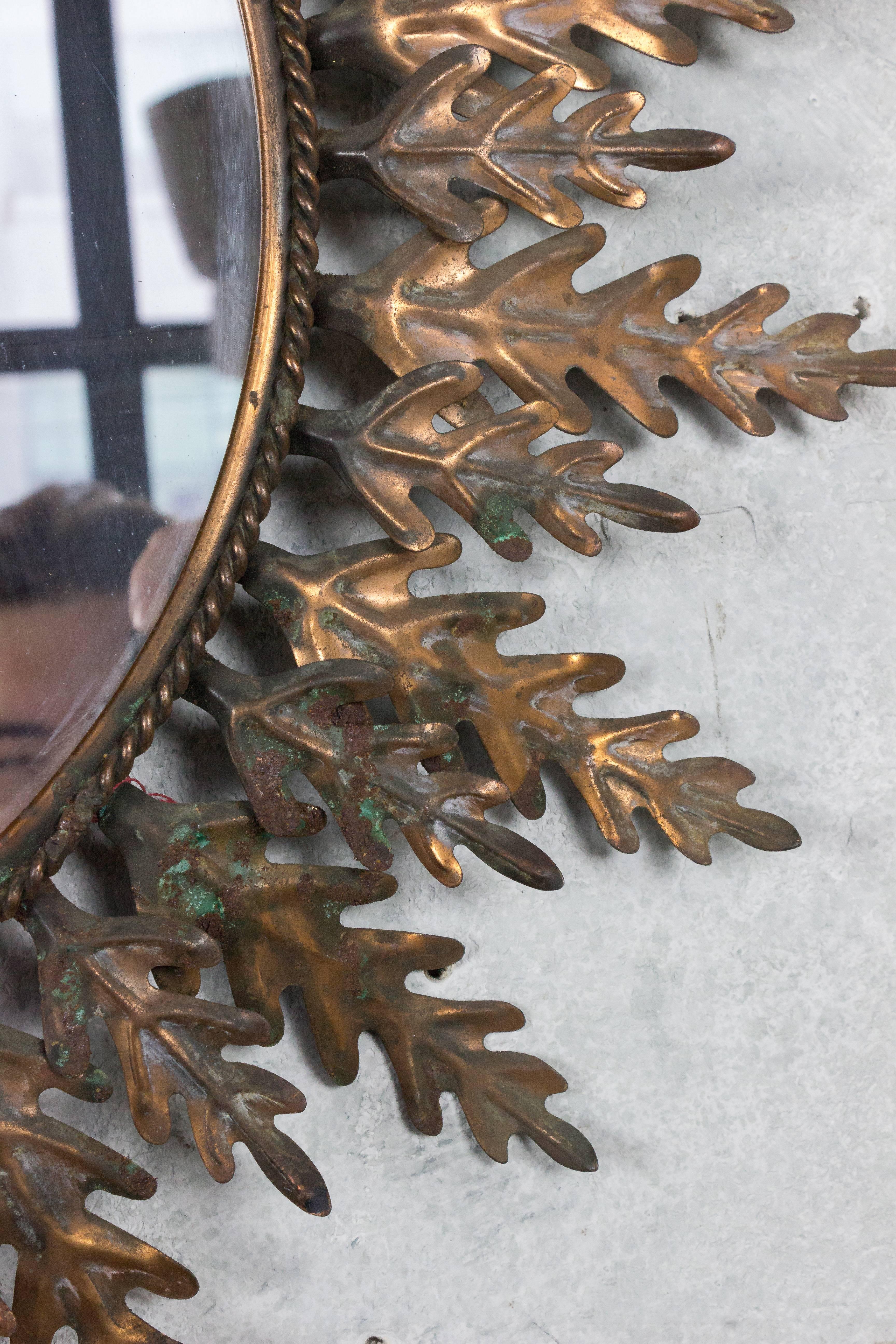 Round copper framed sunburst mirror.
