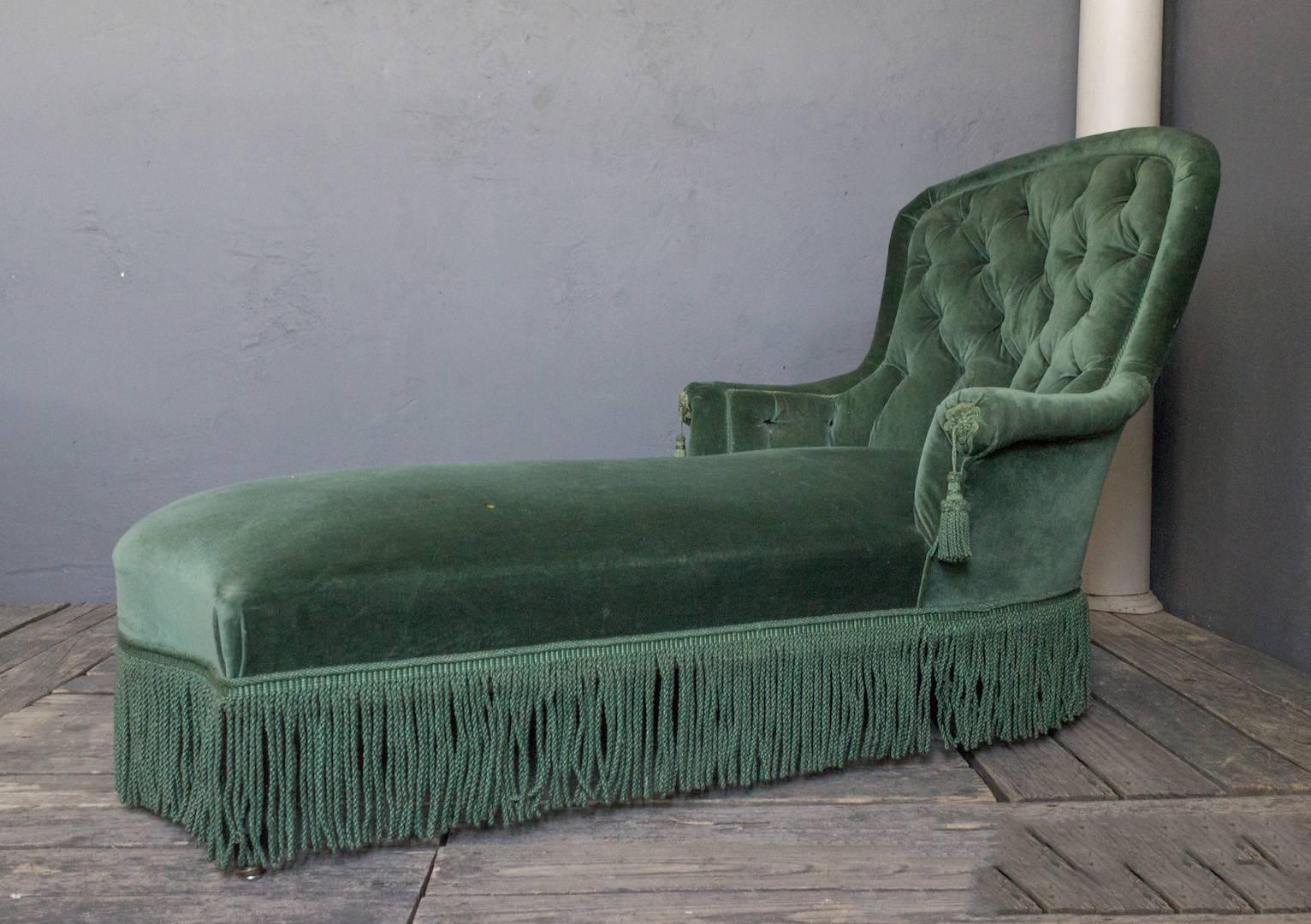 A stunning French 19th century Napoleon III tufted chaise lounge. Instantly add a breathtaking piece of French 19th century elegance to your home with this Napoleon III tufted chaise lounge in green velvet. Featuring a rounded back and decorative