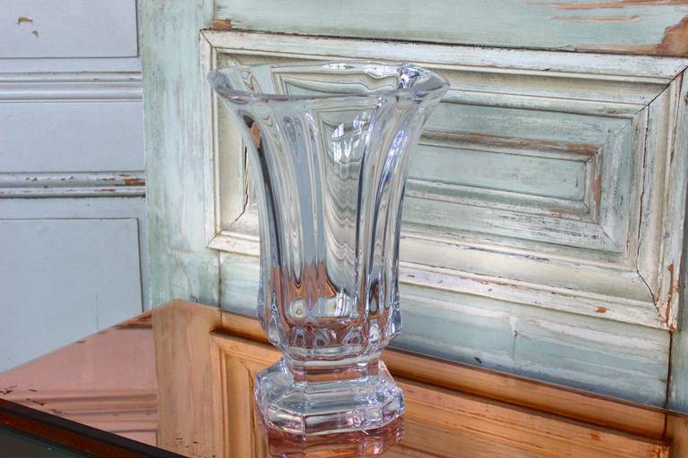 Very heavy glass vase with a square base and large opening at top.