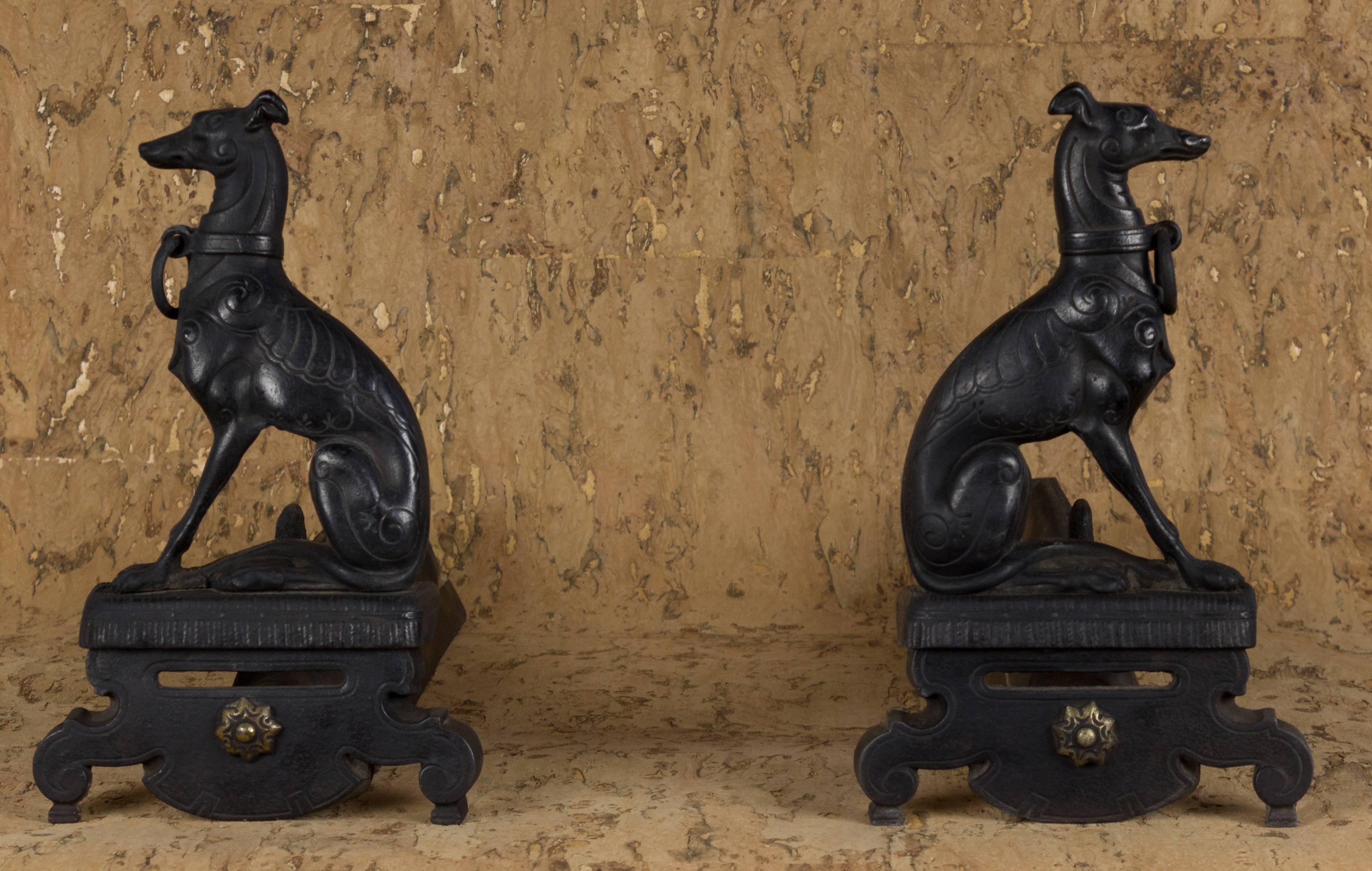 Pair of French cast iron whippets andirons with brass details.