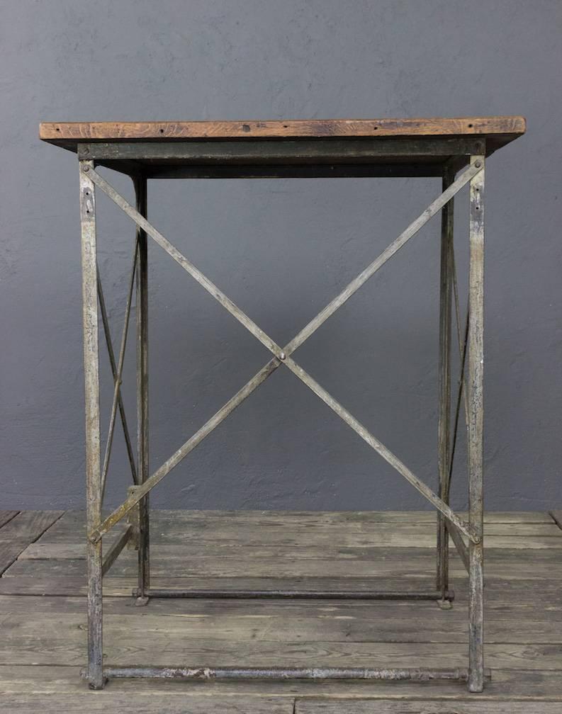 Early century French factory table with iron frame base and oak top.
 